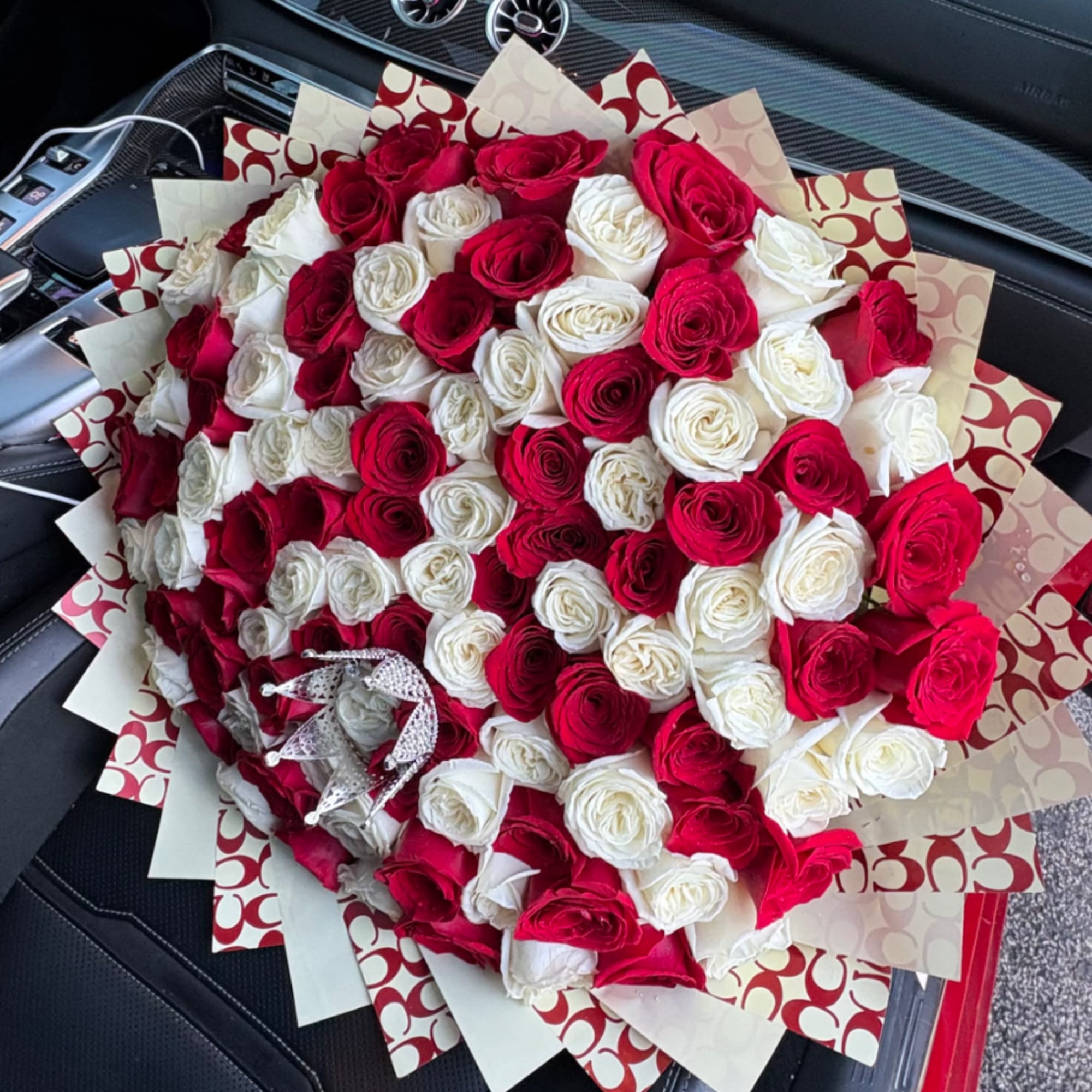 Large bouquet of red and white roses with patterned wrapping