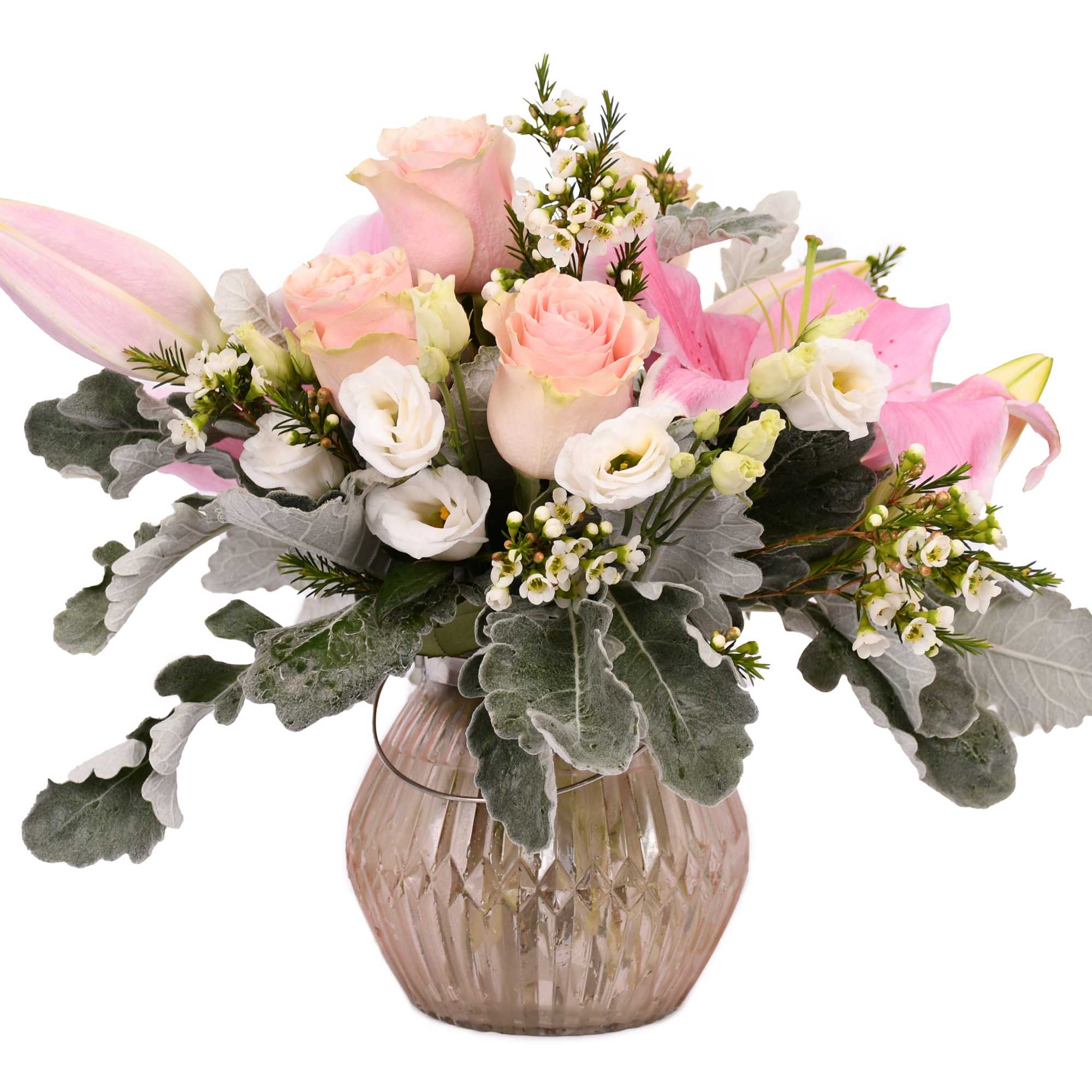 Pink roses and lilies arranged in a glass vase with white accent flowers