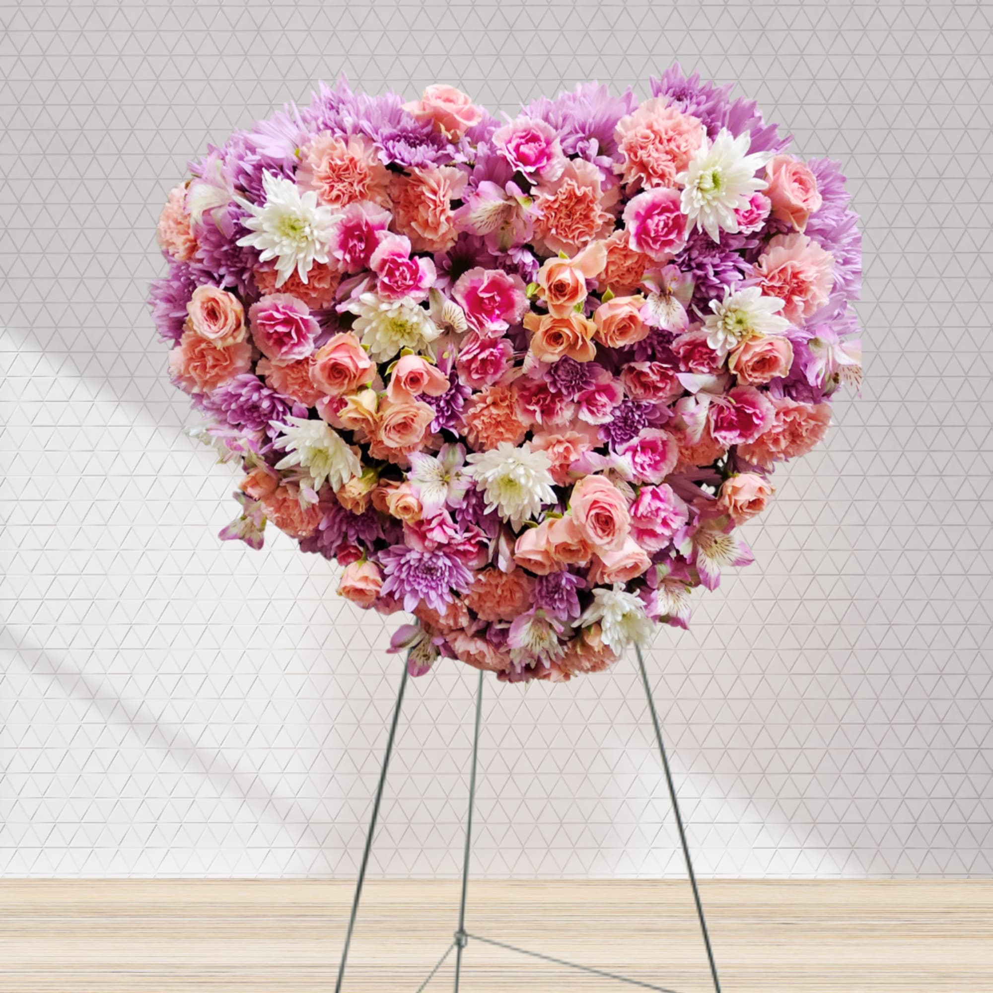 In Loving Radiance is a stunning heart-shaped funeral spray crafted to express