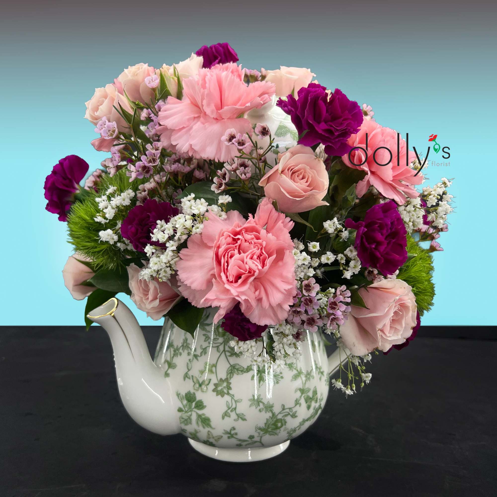 A dense, rounded cluster of blush and deep purple blooms arranged in, photo 2 of 3