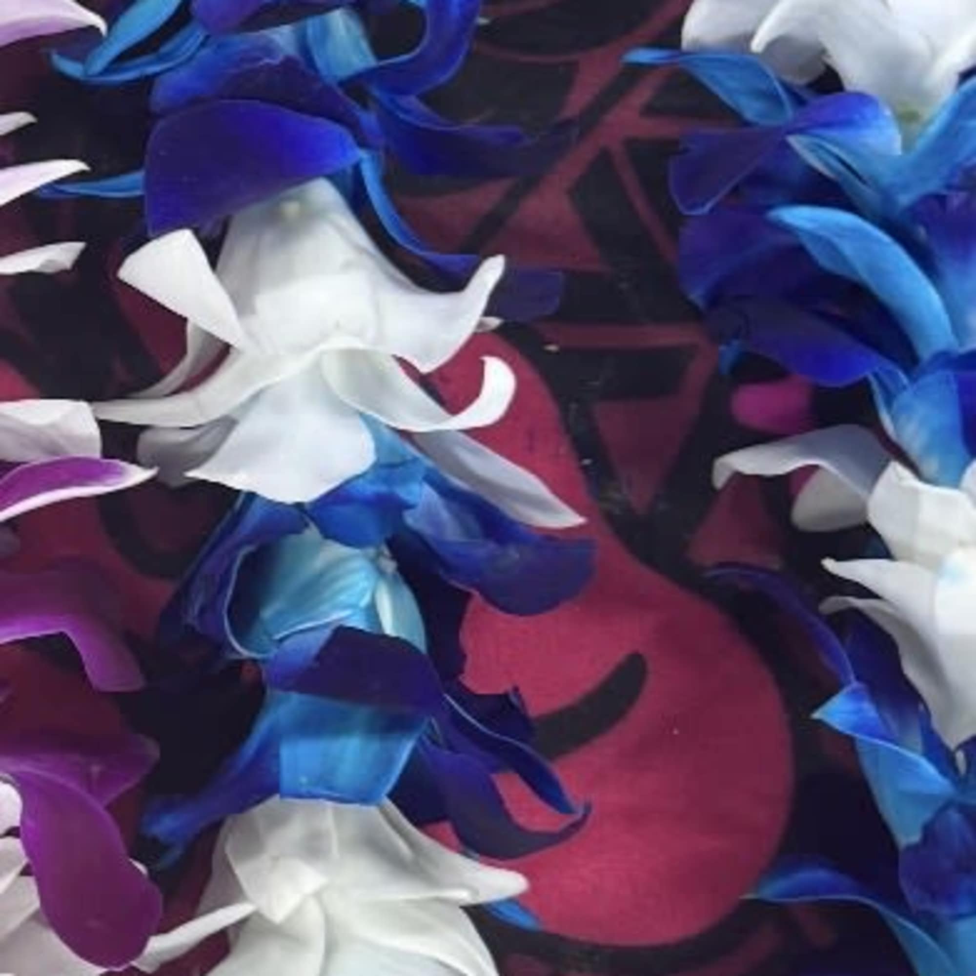 Electric-blue orchid leis that read like a bold island celebration - perfect