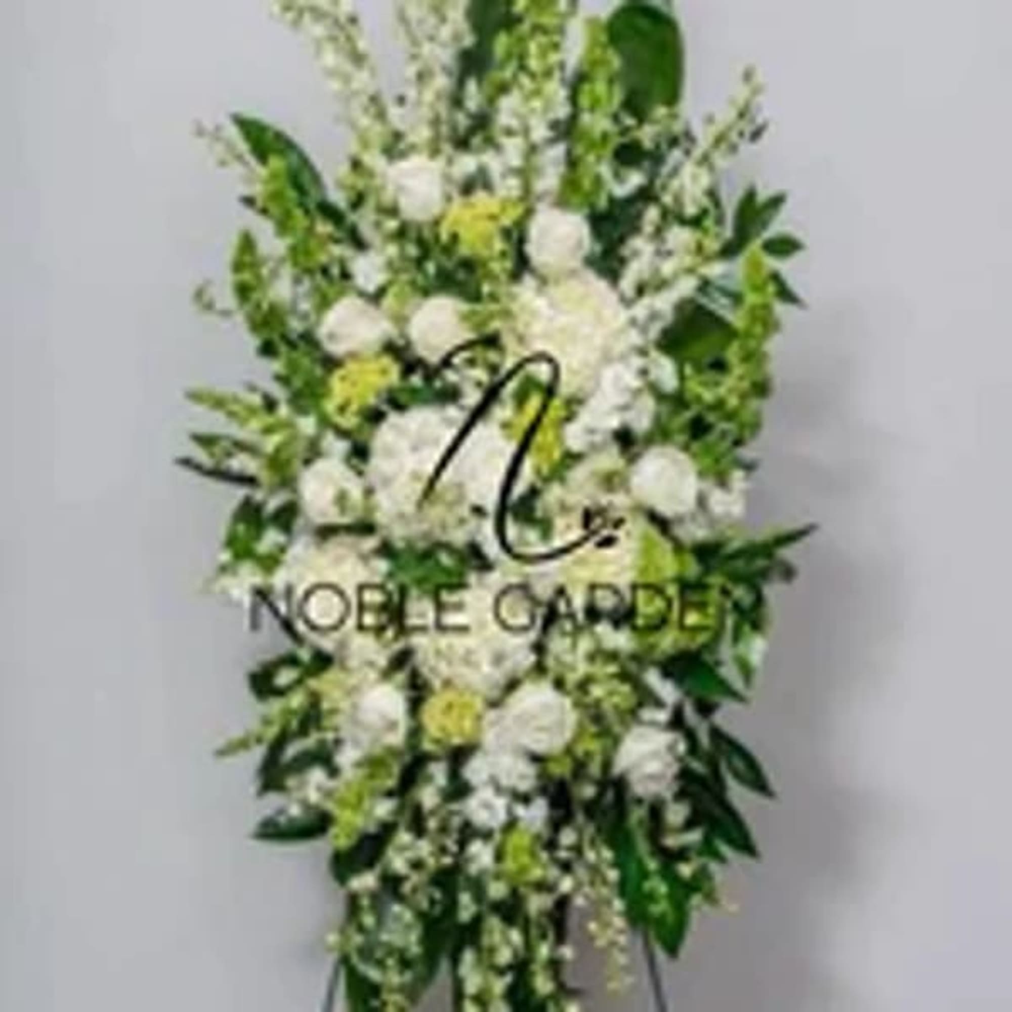 Tall white and green standing floral spray with mixed blooms