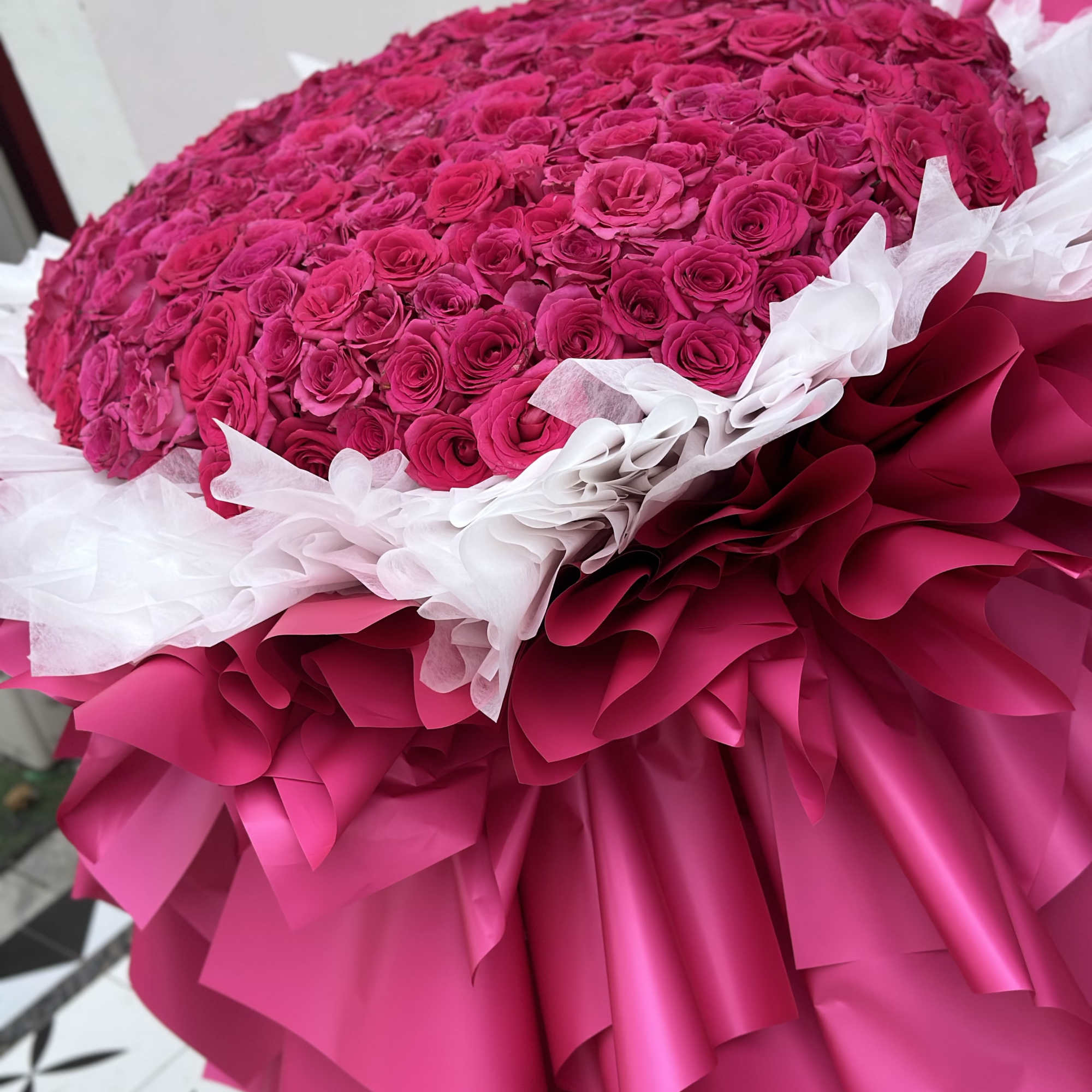 Large bouquet of hot pink roses wrapped in pink and white paper, photo 3 of 5