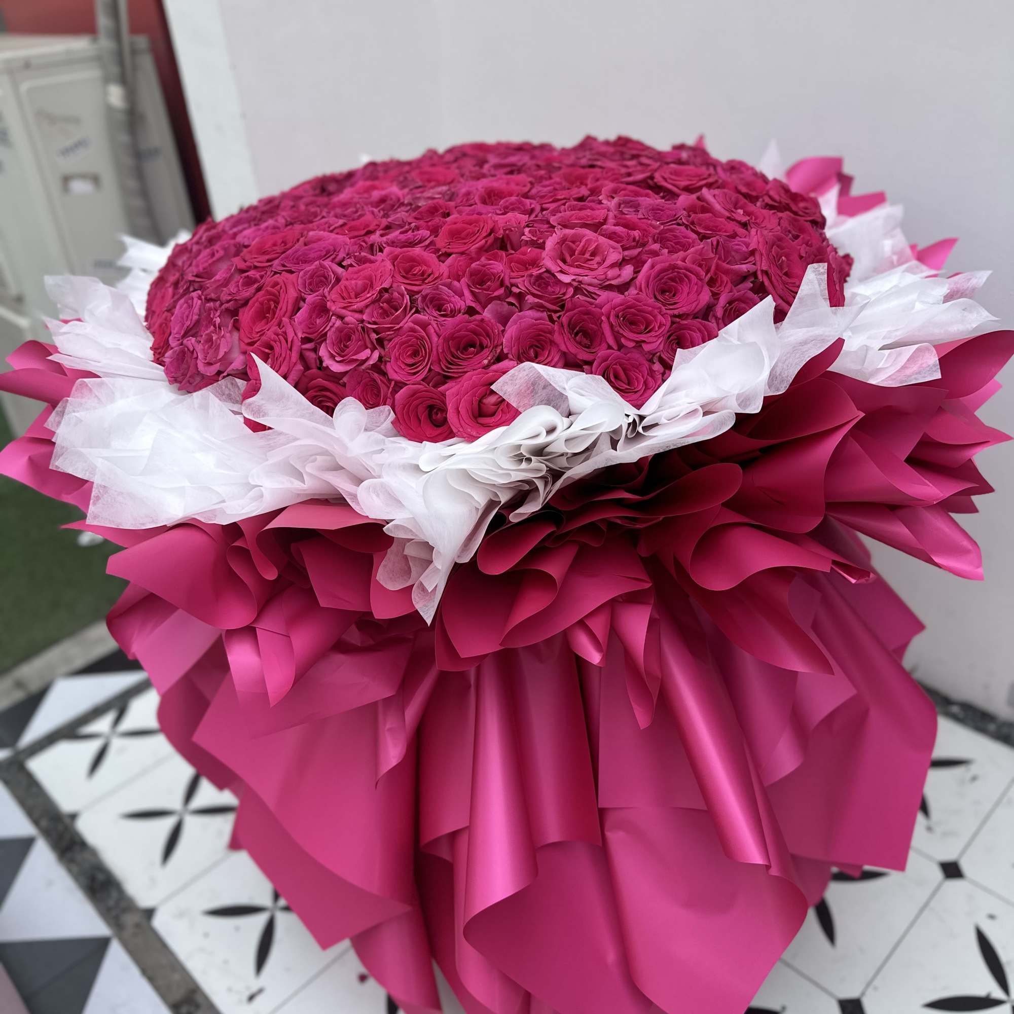 Large bouquet of hot pink roses wrapped in pink and white paper, photo 4 of 5