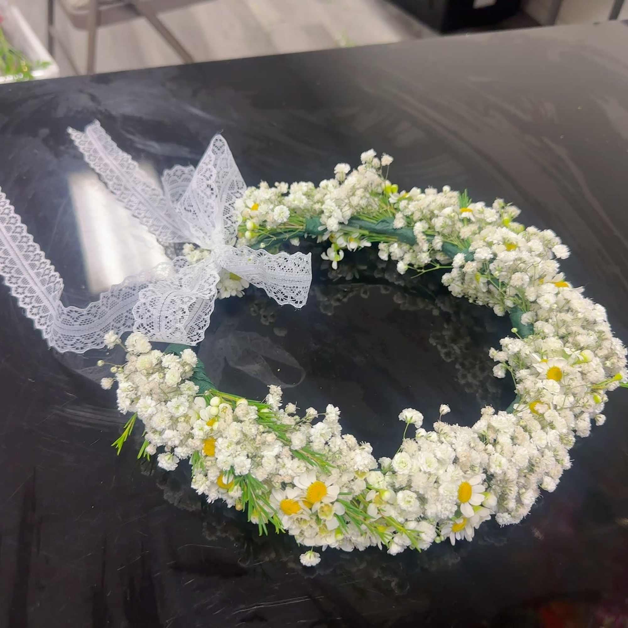 White floral crown with small daisies and lace ribbon
