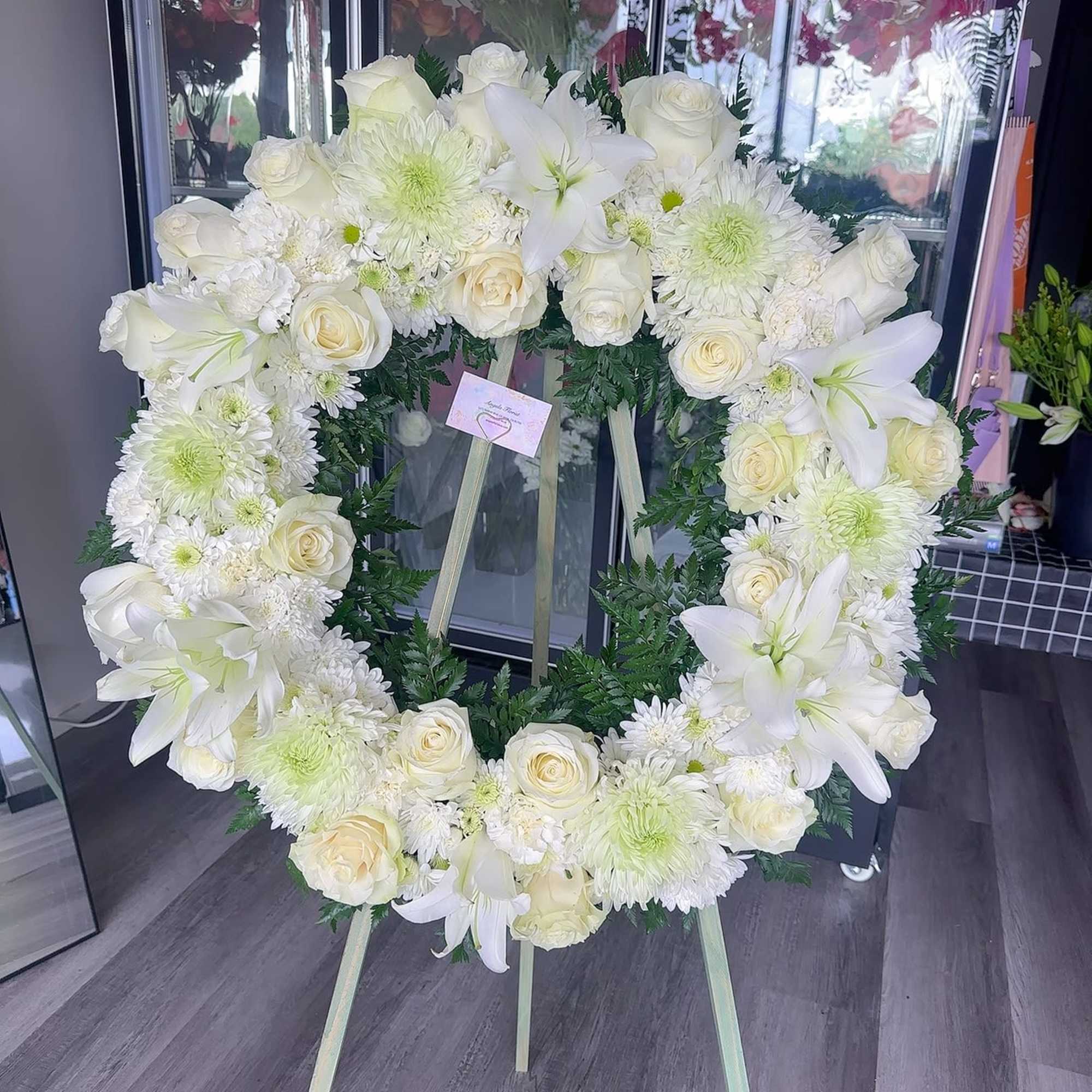 White floral wreath on a standing easel