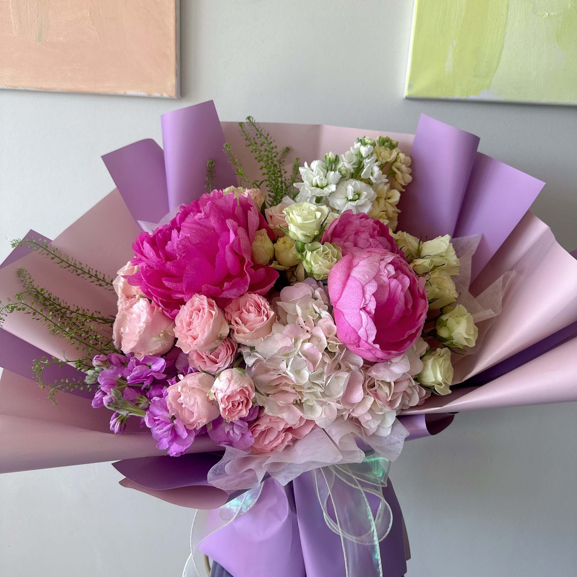 Pink and white mixed bouquet wrapped in lavender paper