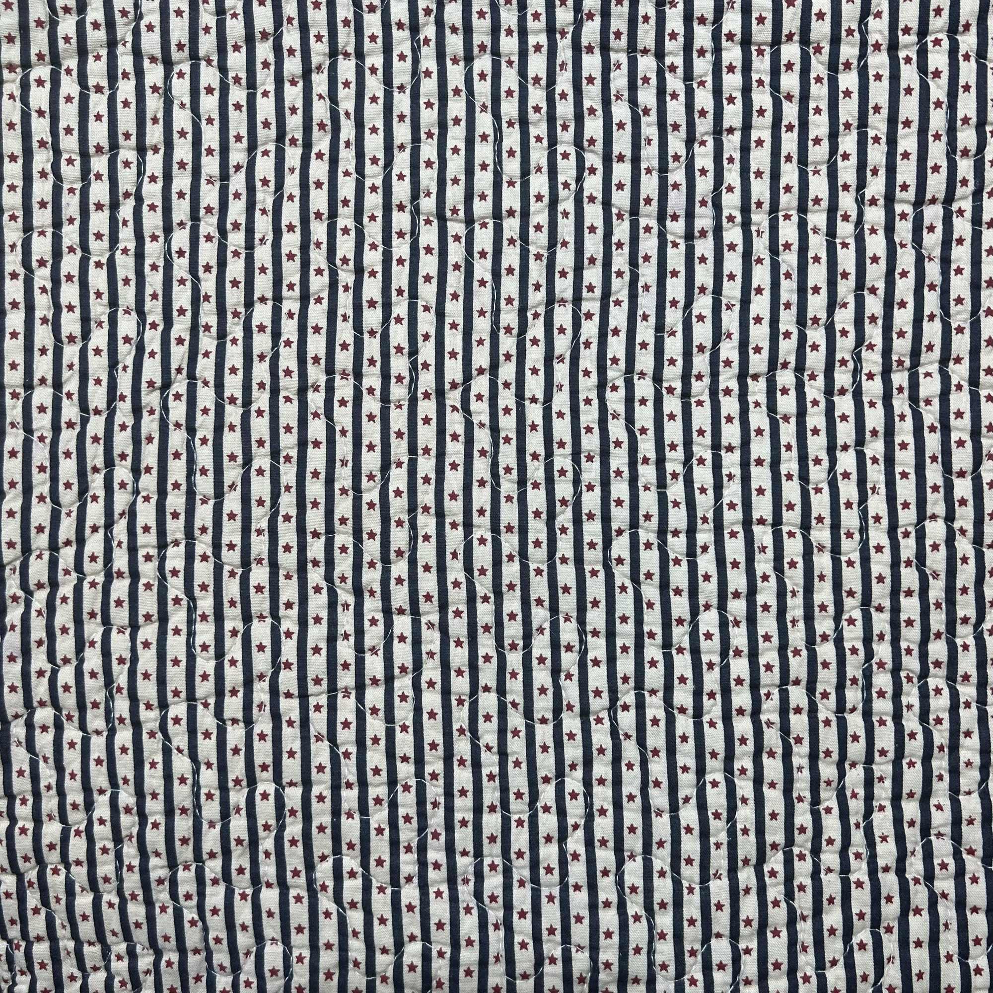 Quilted fabric with navy stripes and small red stars