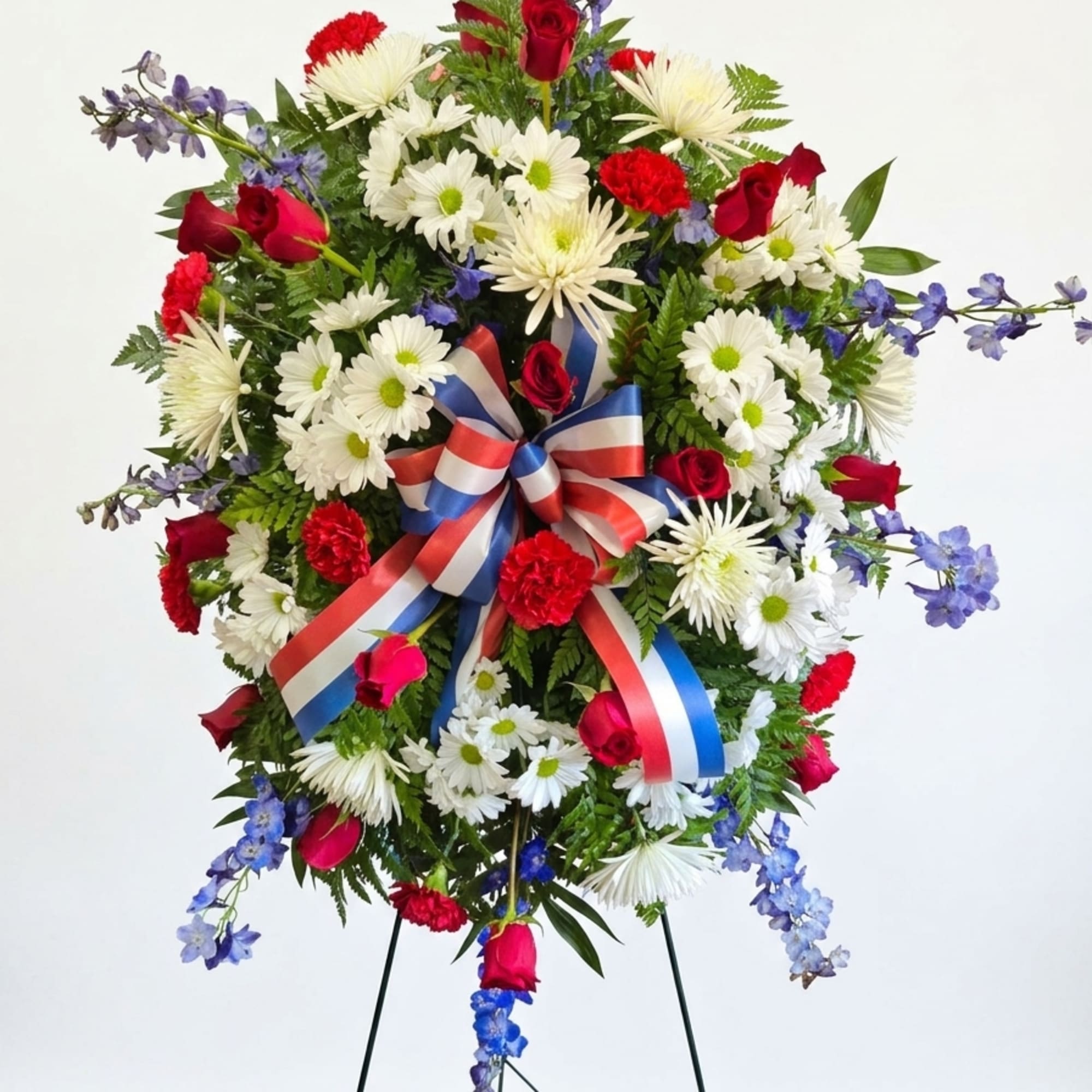 A full circular standing spray that reads as both patriotic and reverent