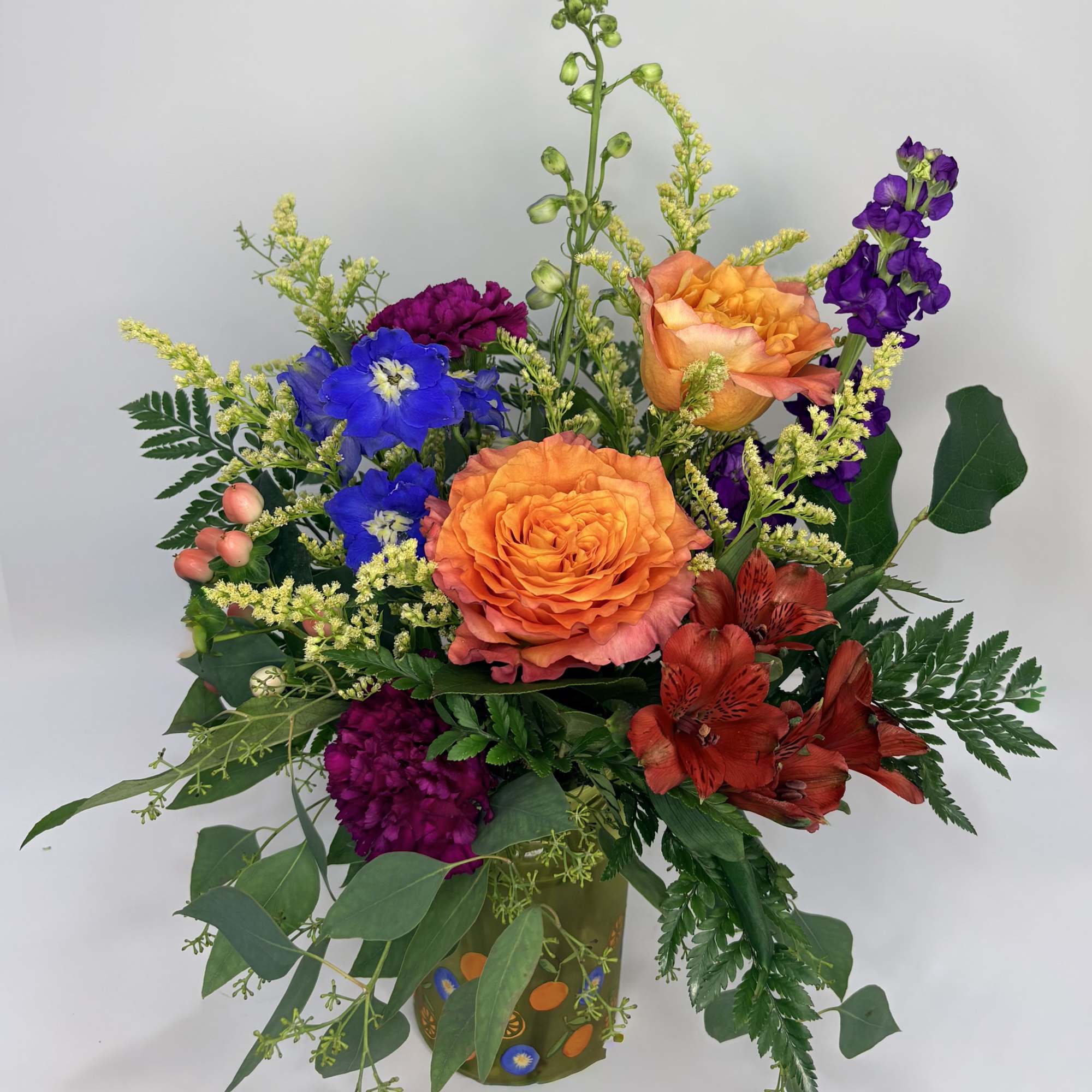 Fruit Punch is a delicious mix of orange roses, blue delphinium, purple