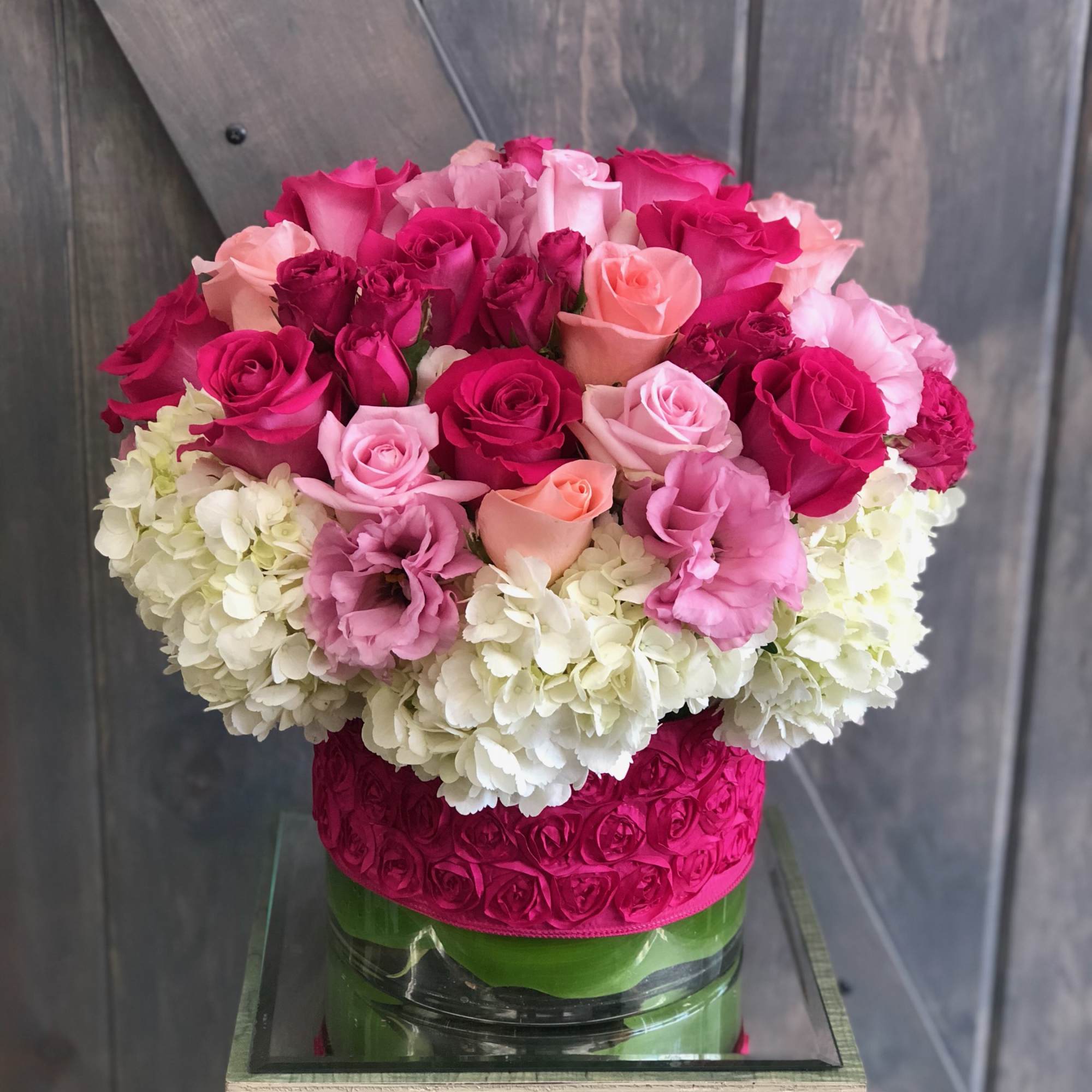 Pink and white rose bouquet in a glass vase
