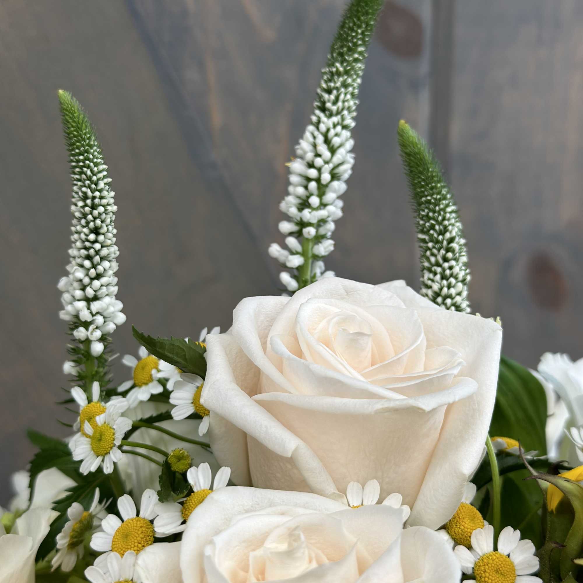 White roses with small daisy flowers and tall white spikes