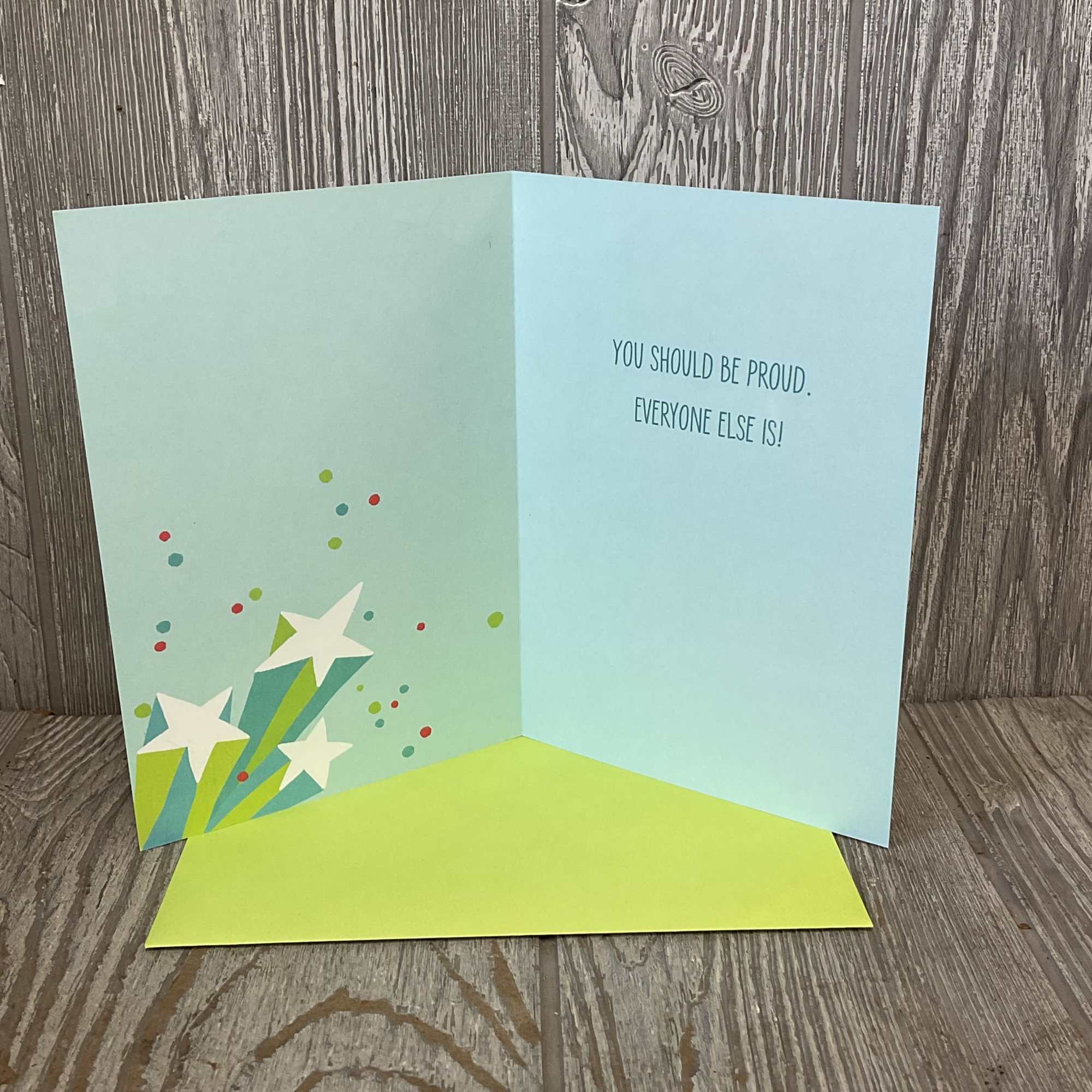 Folded greeting card with a colorful starburst design and printed message