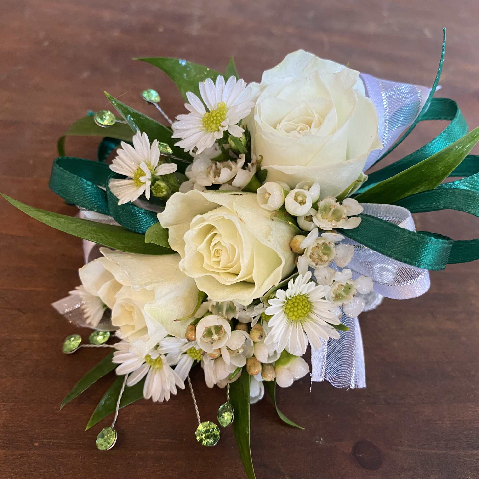 Small white rose corsage with daisies and teal ribbon
