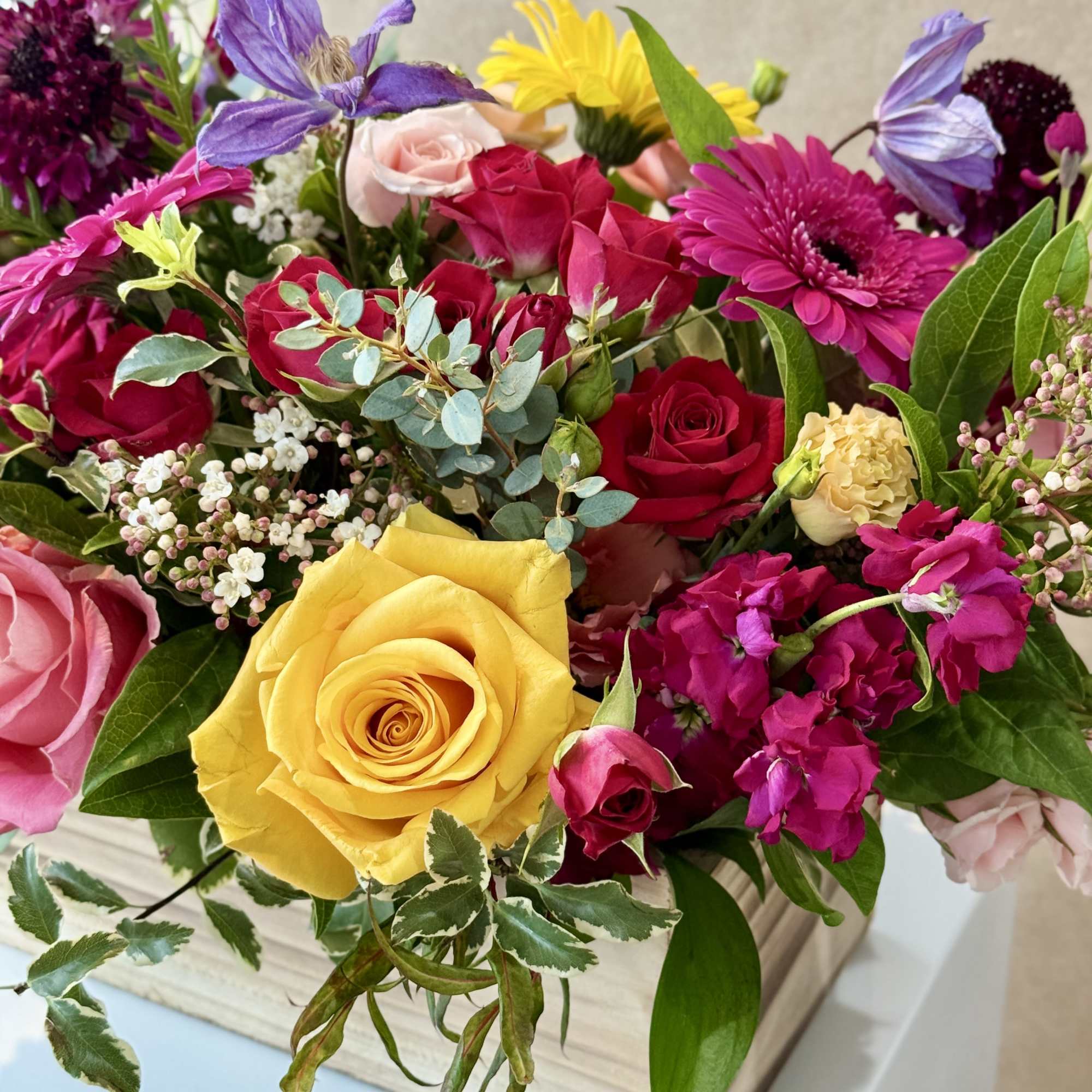 Mixed bouquet of roses, gerbera daisies, and purple blooms in a wooden box, photo 4 of 5
