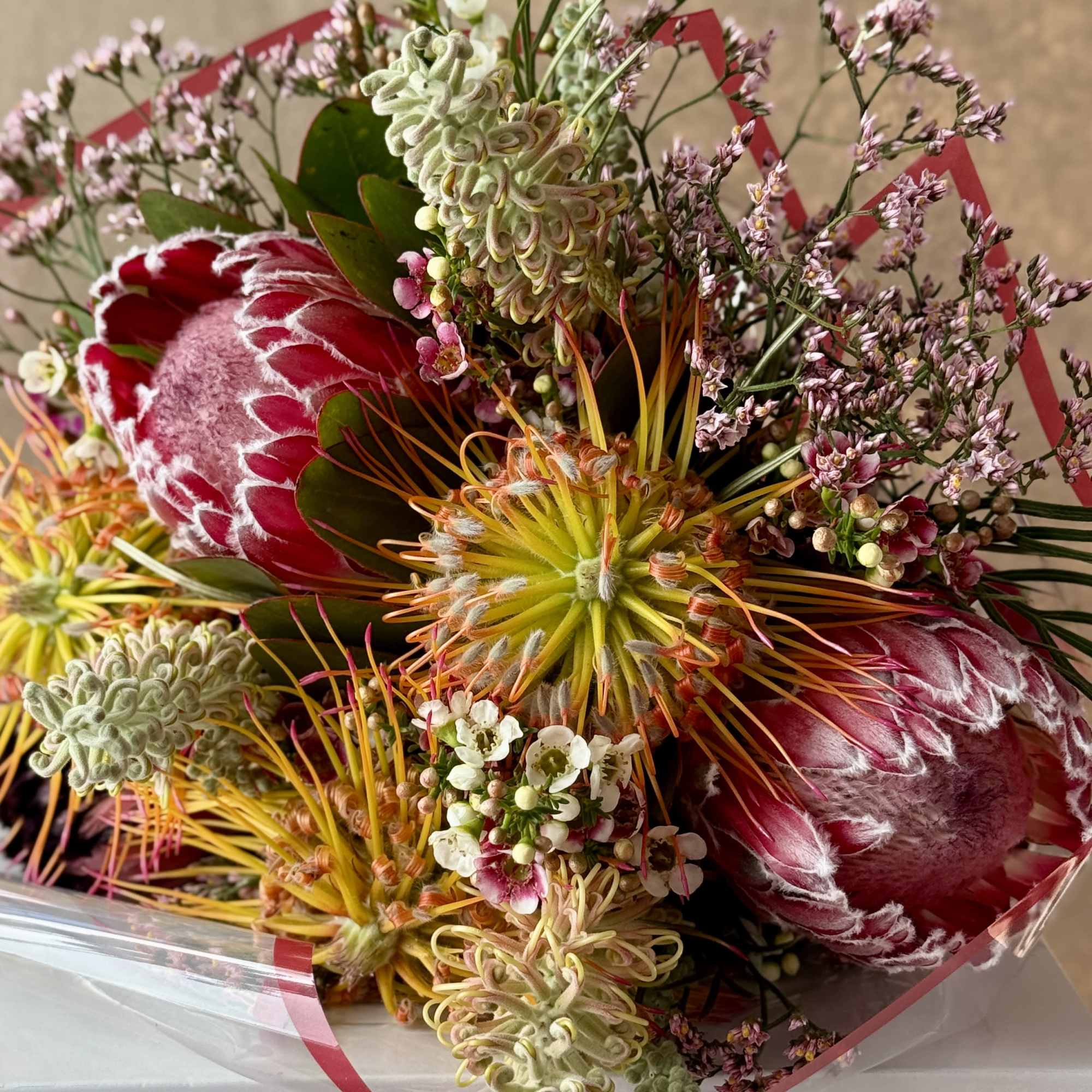Exotic bouquet with protea and grevillea with seasonal accents., photo 2 of 2