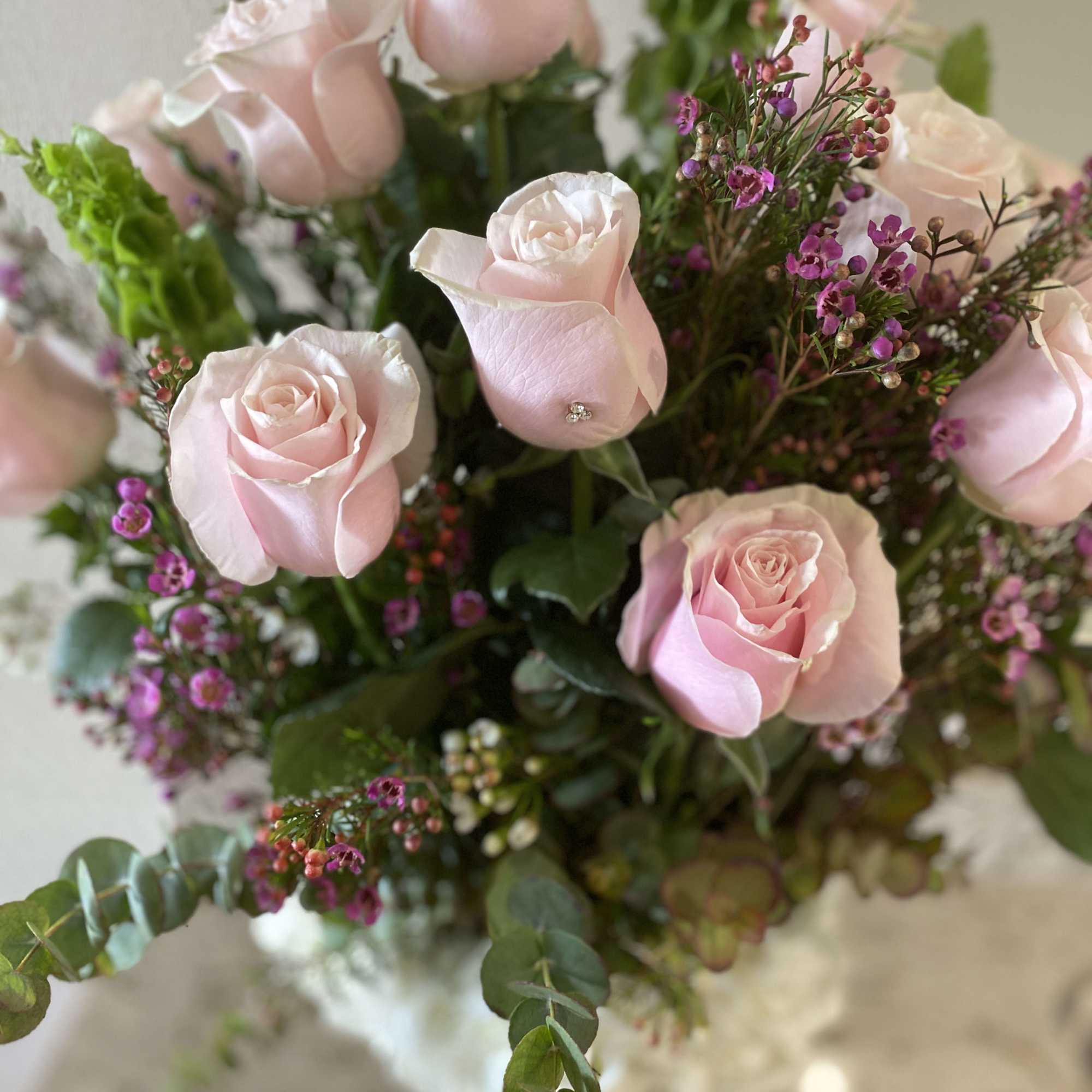 Bouquet of pale pink roses with purple filler flowers
