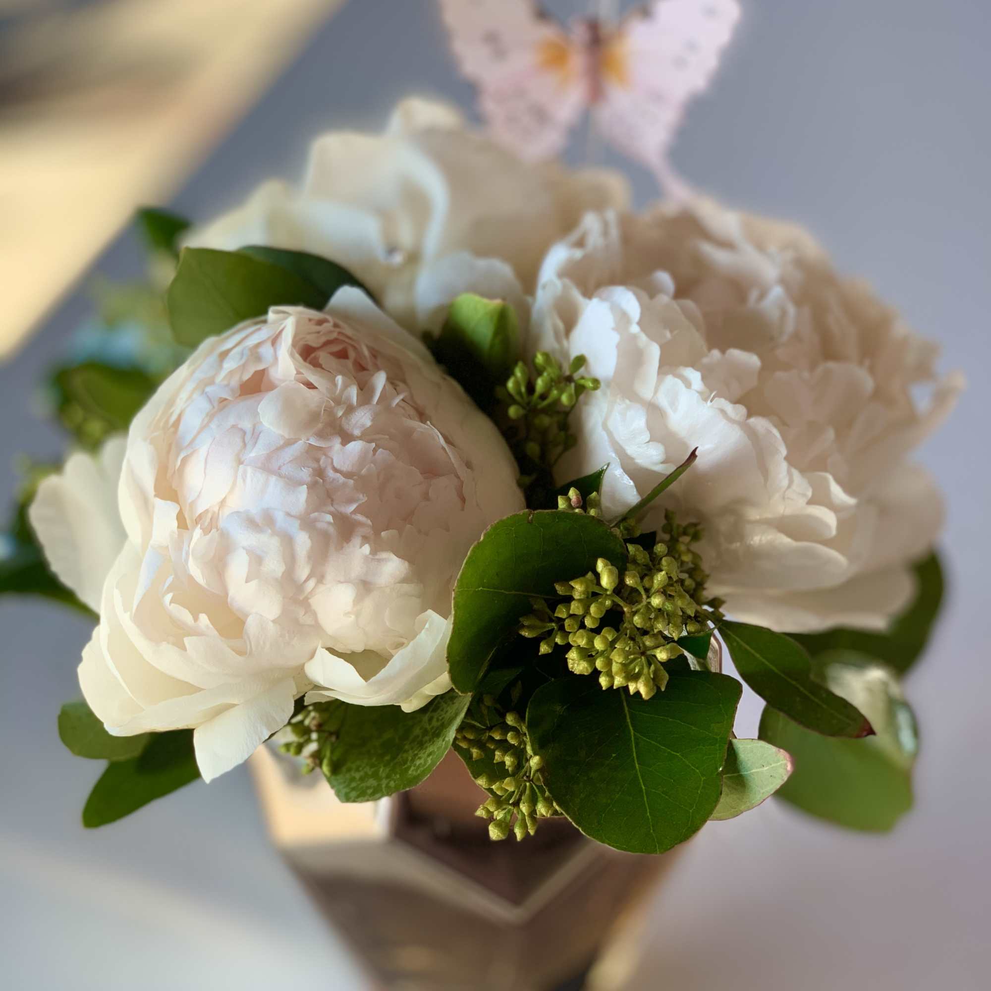 Bouquet of pale pink and white peonies in a vase