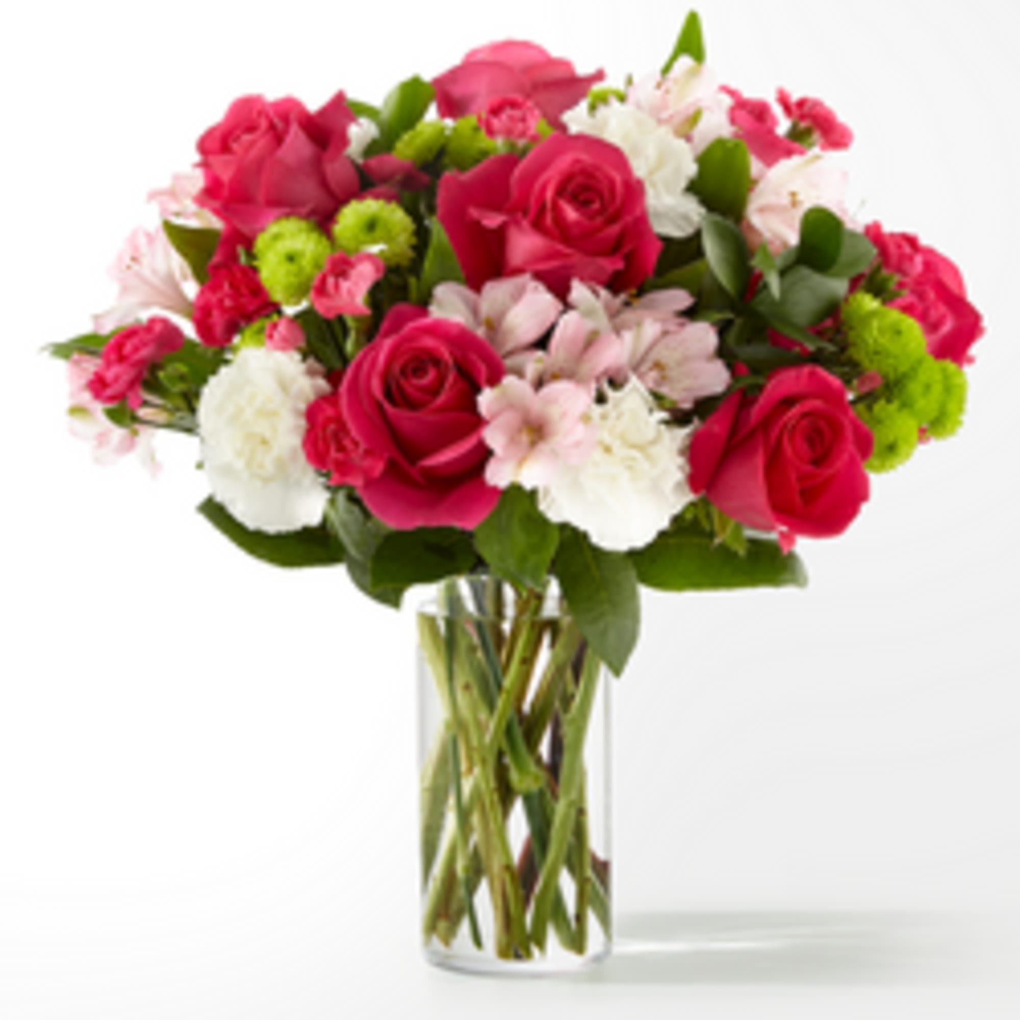 Bouquet of pink roses, white carnations, and green button mums in a glass vase