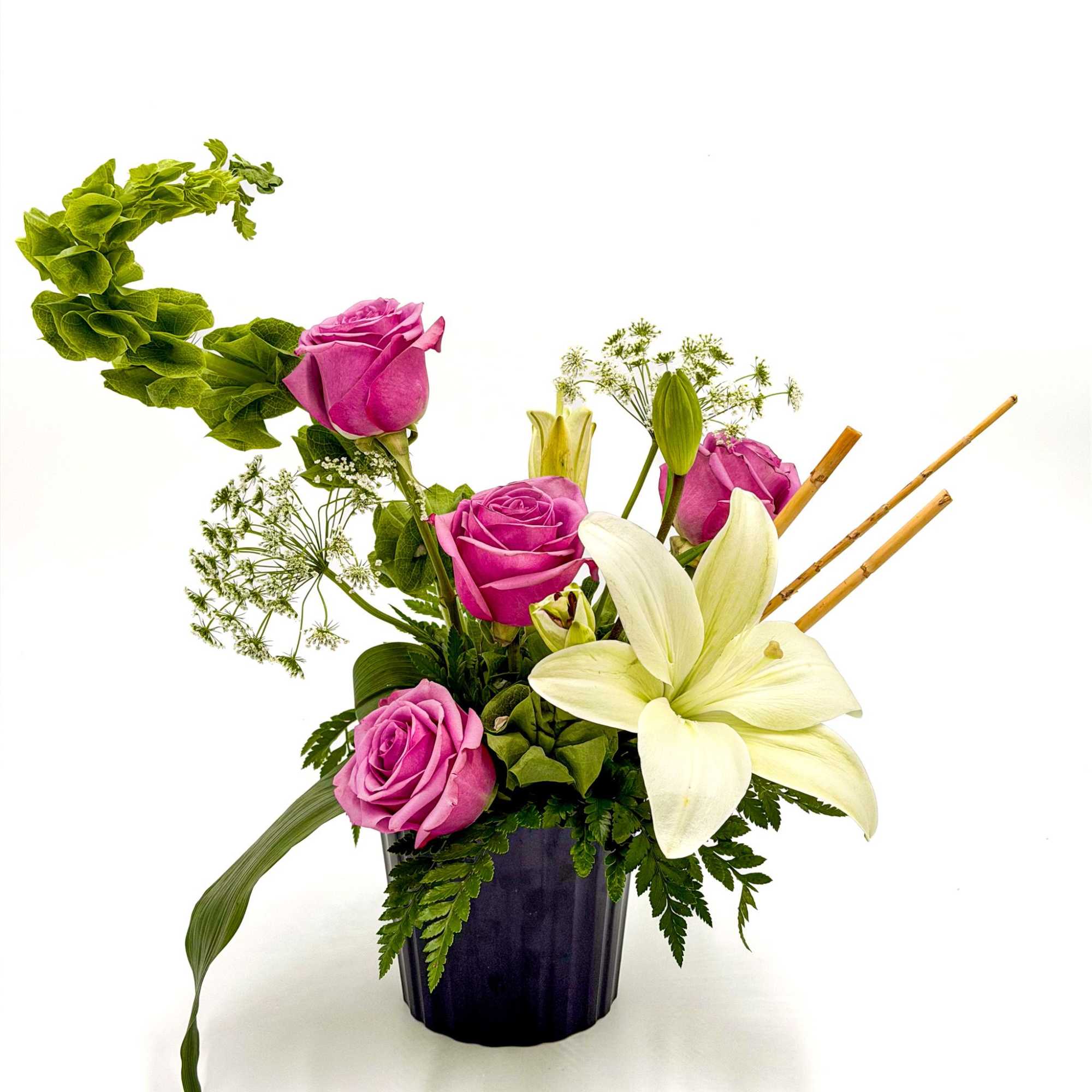 A graceful blend of lavender roses and elegant white lilies creates a, photo 2 of 2
