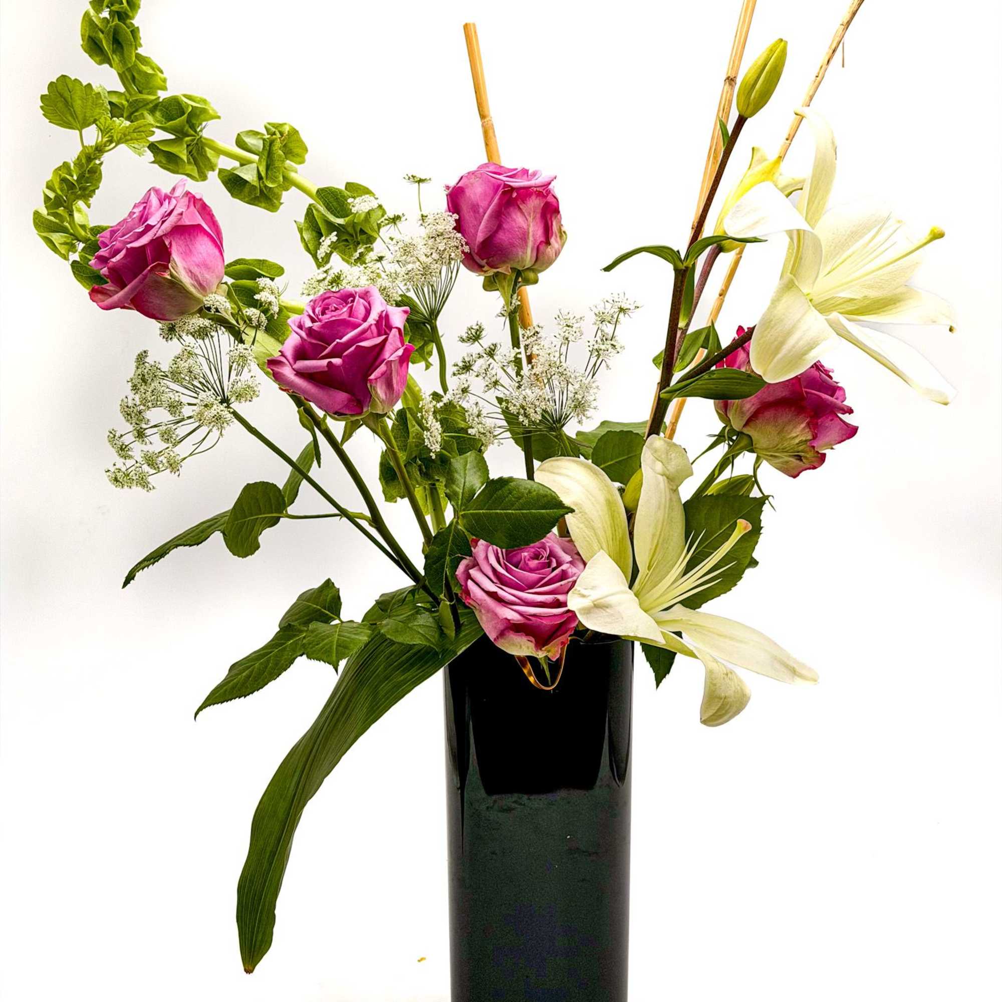 A graceful blend of lavender roses and elegant white lilies creates a, photo 2 of 2