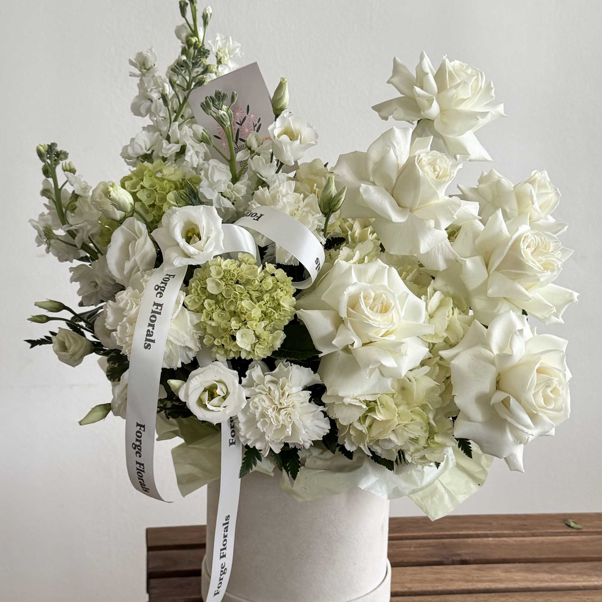 A soft, sculptural design in creamy whites and fresh greens. Layered roses, photo 3 of 3