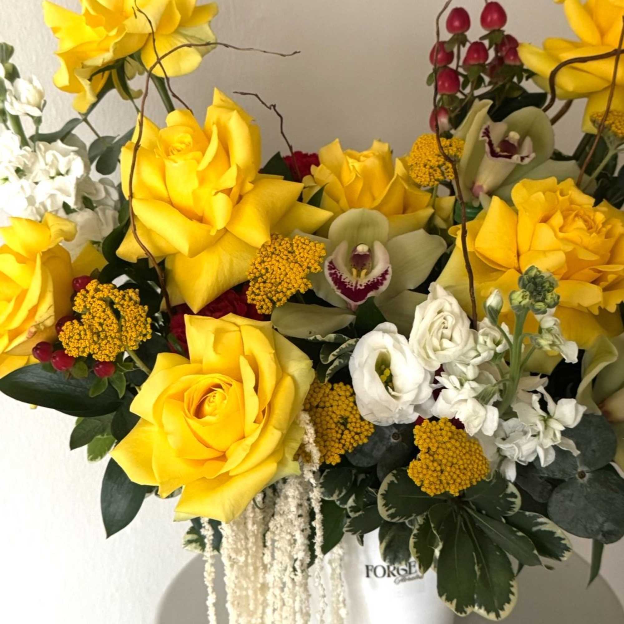 A bright and elegant arrangement featuring vibrant yellow roses, orchids, seasonal blooms, photo 2 of 2