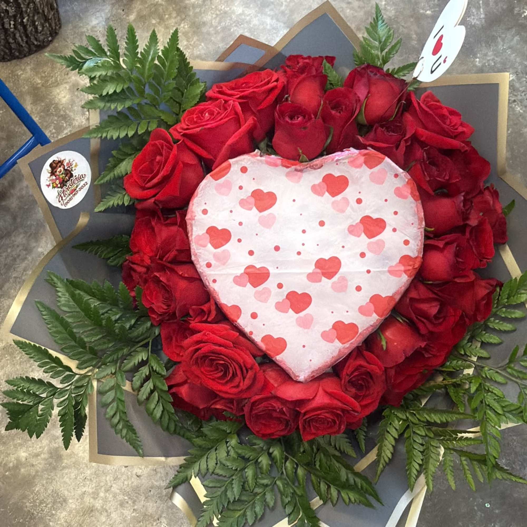 Heart-shaped rose arrangement with a heart gift box in the center