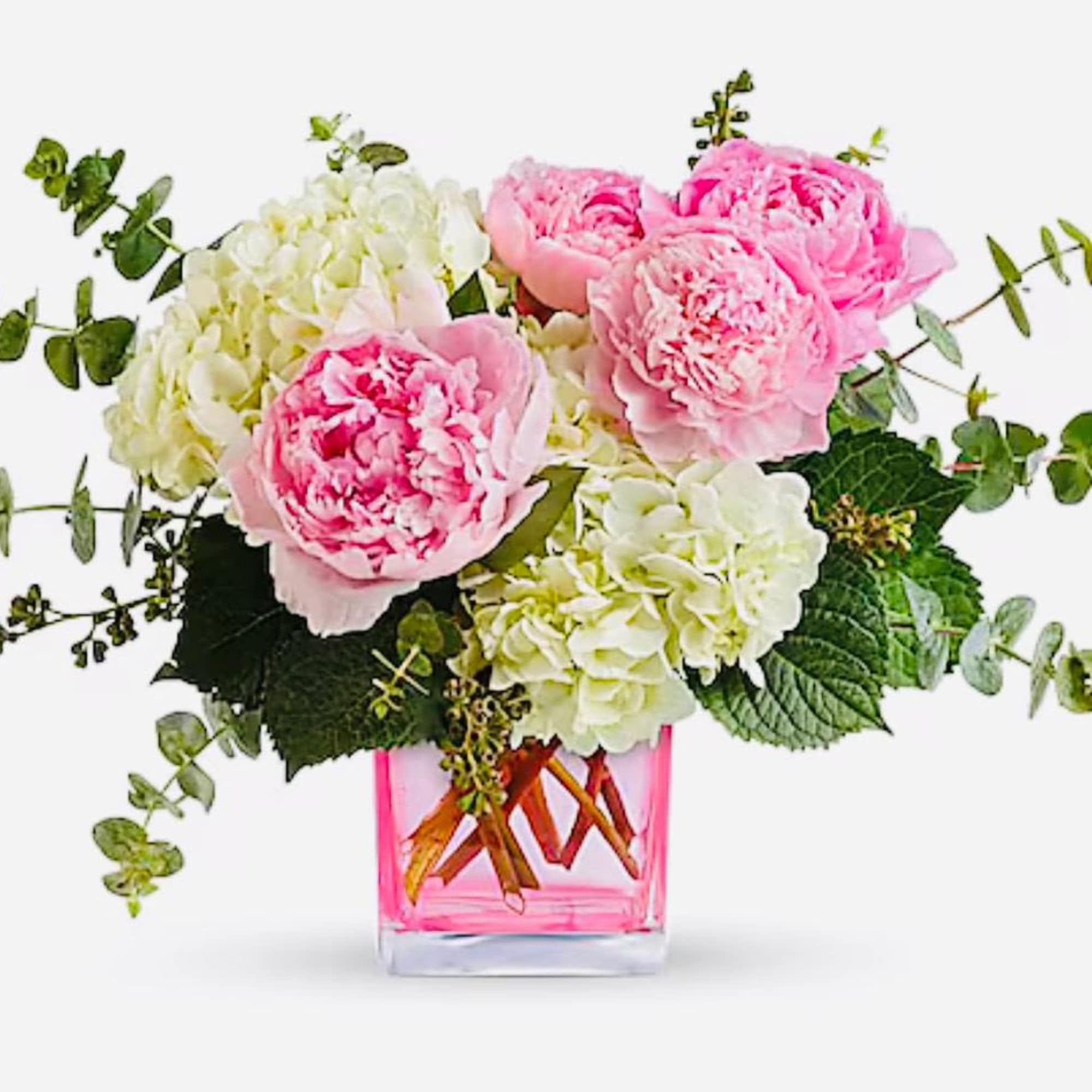 Pink peonies and white hydrangeas in a pink glass vase