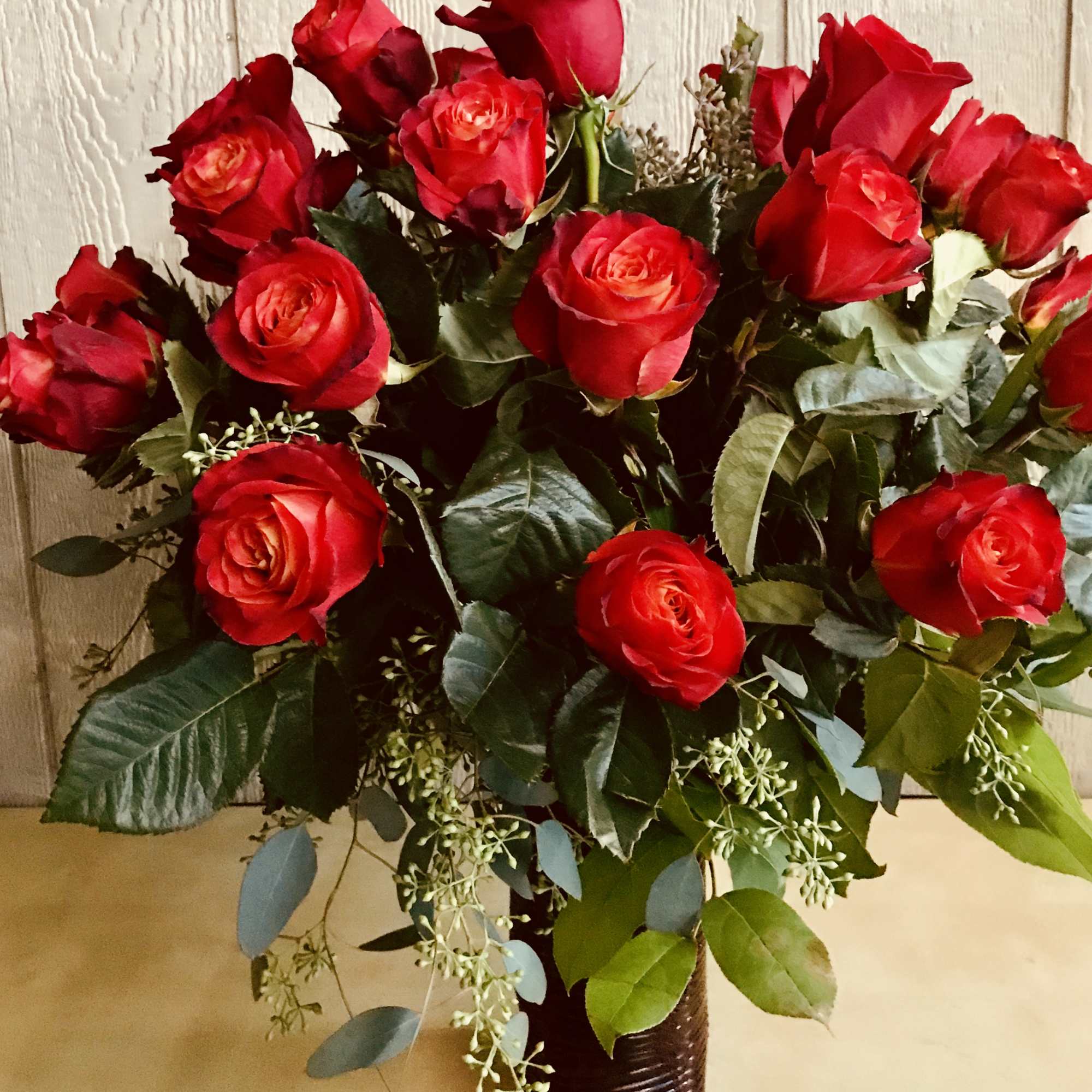Bouquet of red roses in a dark vase