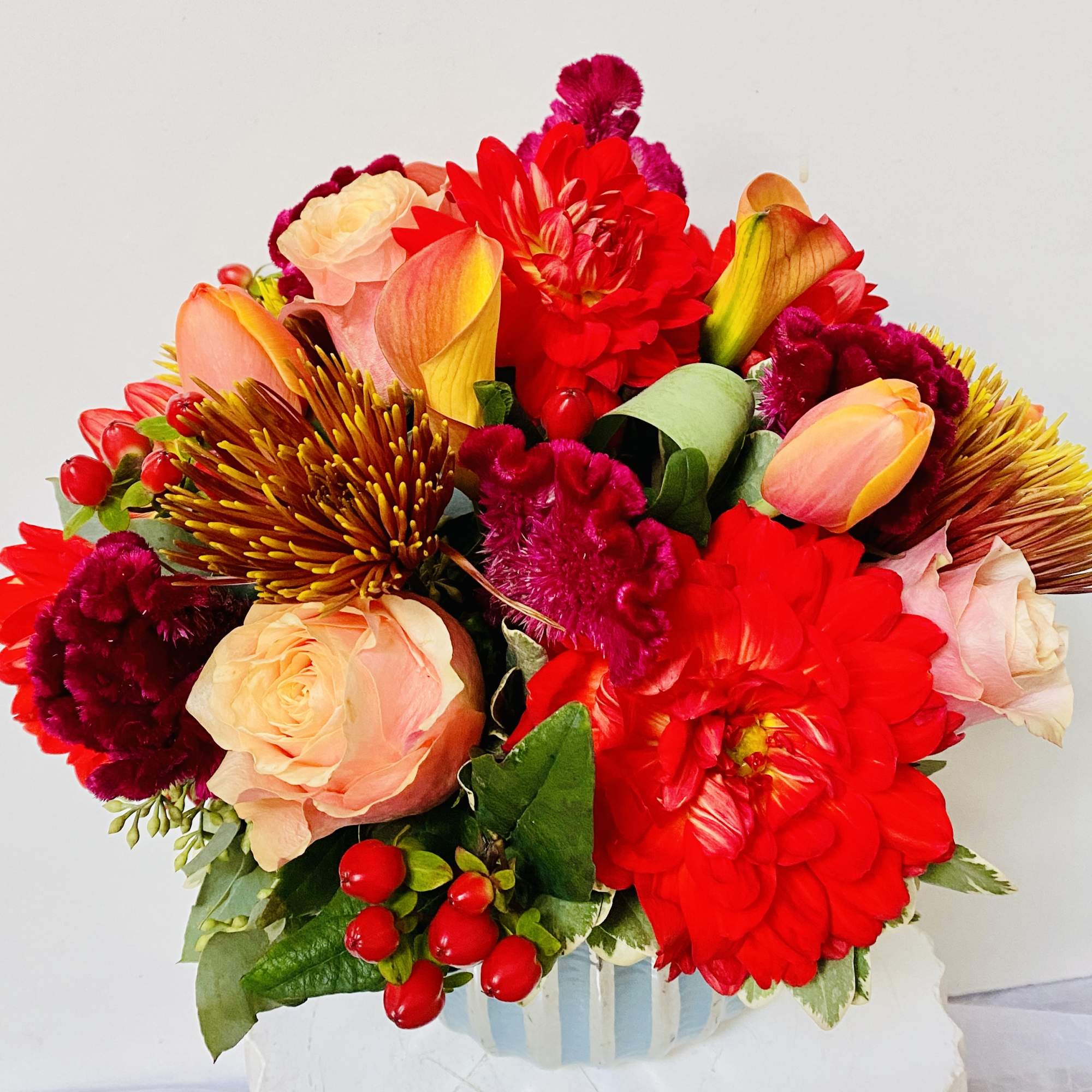 beautiful vase with a spring flowers: tulips, roses, dahlia