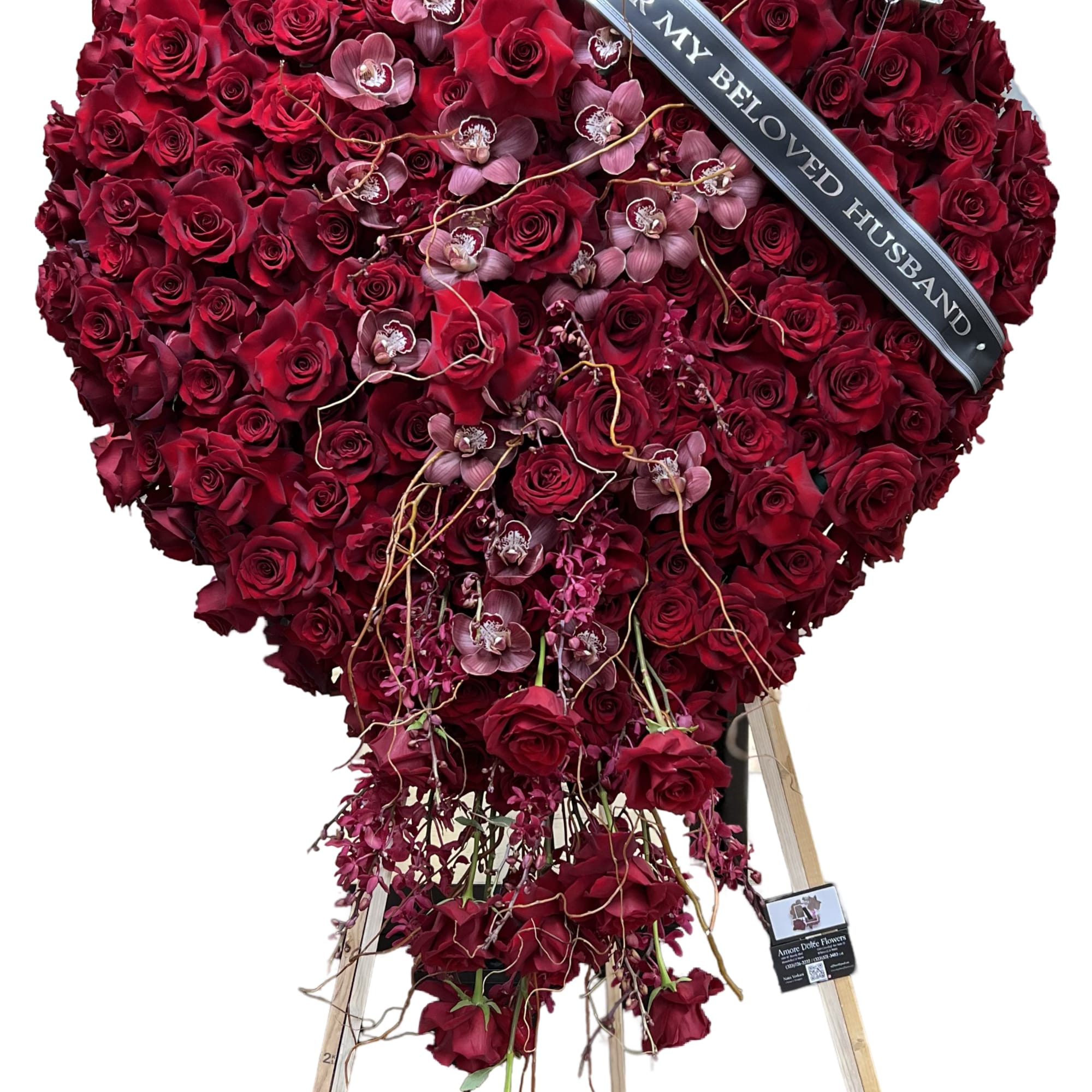 Heart-shaped red rose standing spray with a memorial ribbon