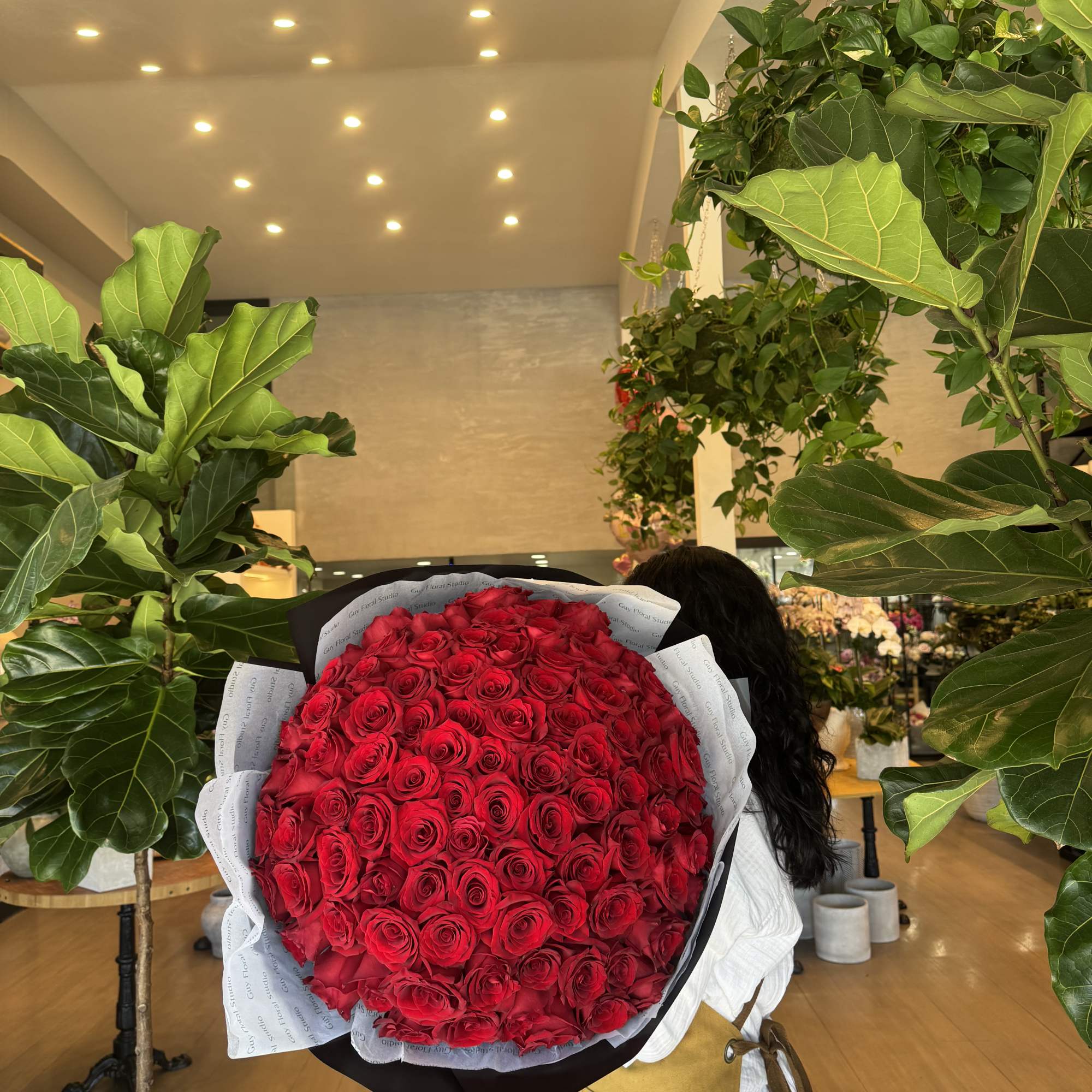 Large bouquet of red roses wrapped in black and white paper, photo 2 of 2