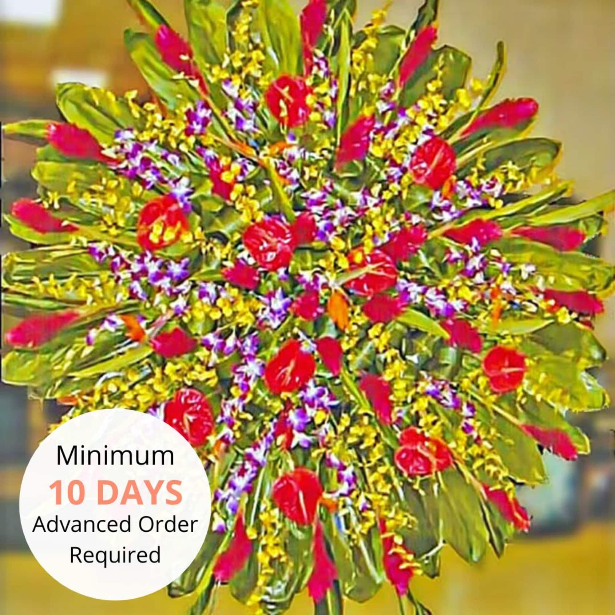 Large circular standing spray with red tropical flowers and yellow and purple blooms
