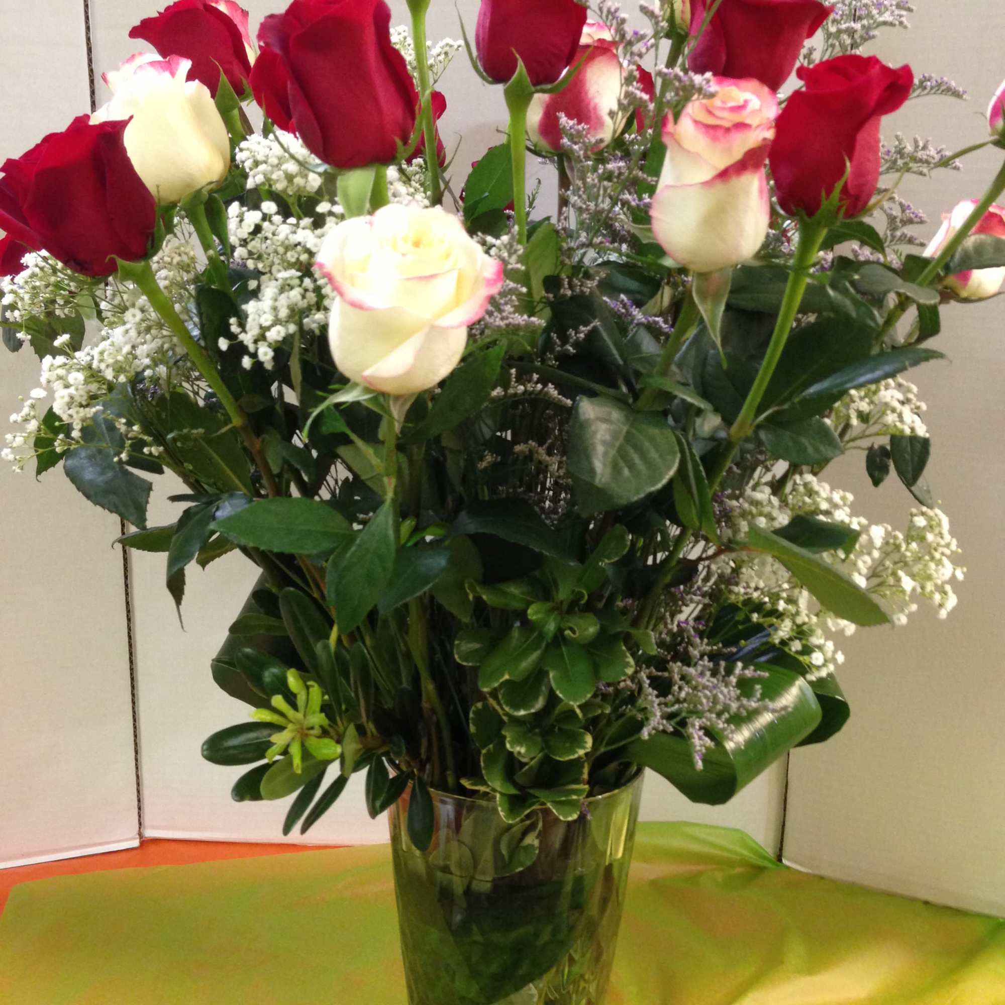 Red and white roses in a clear glass vase
