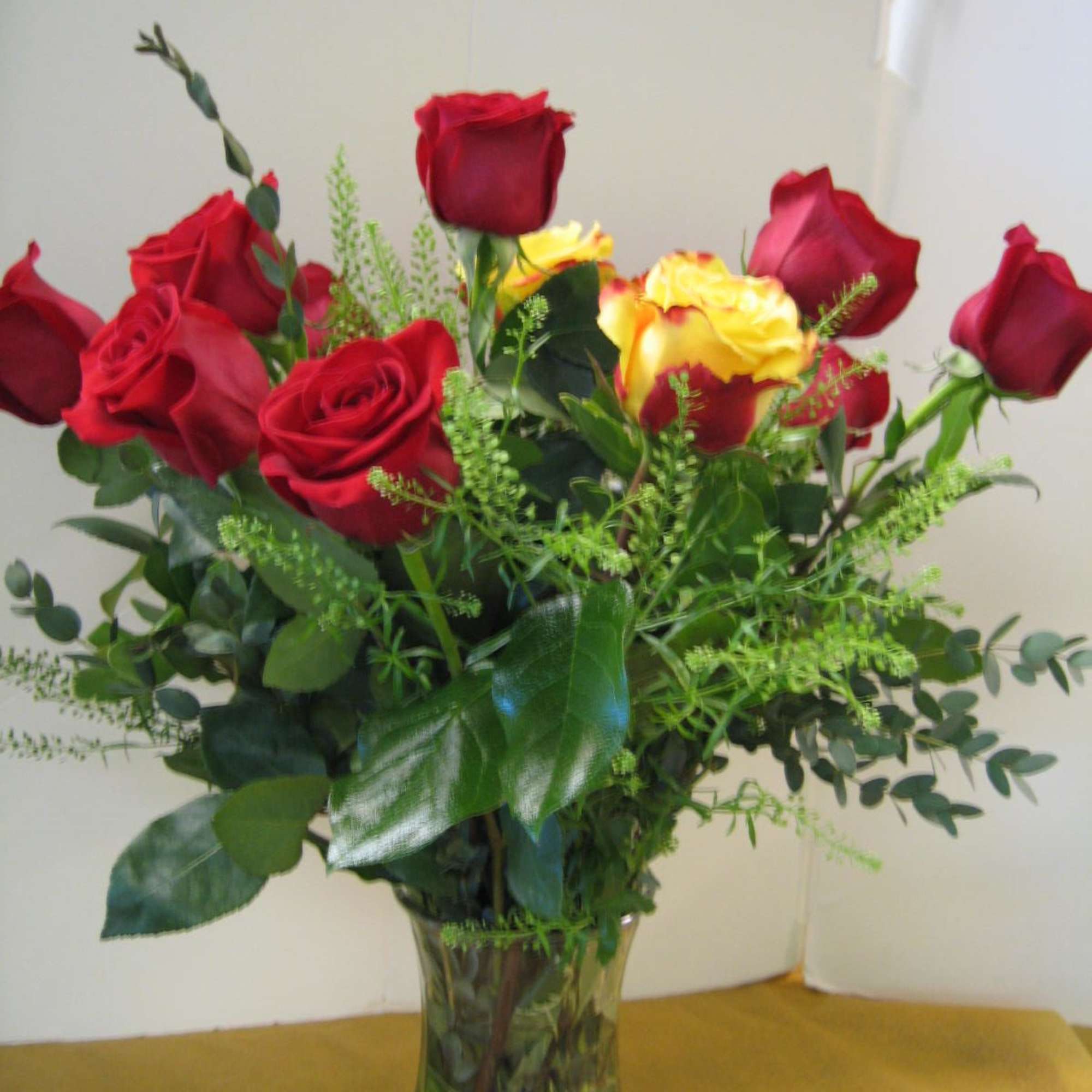 Bouquet of red and yellow roses in a glass vase