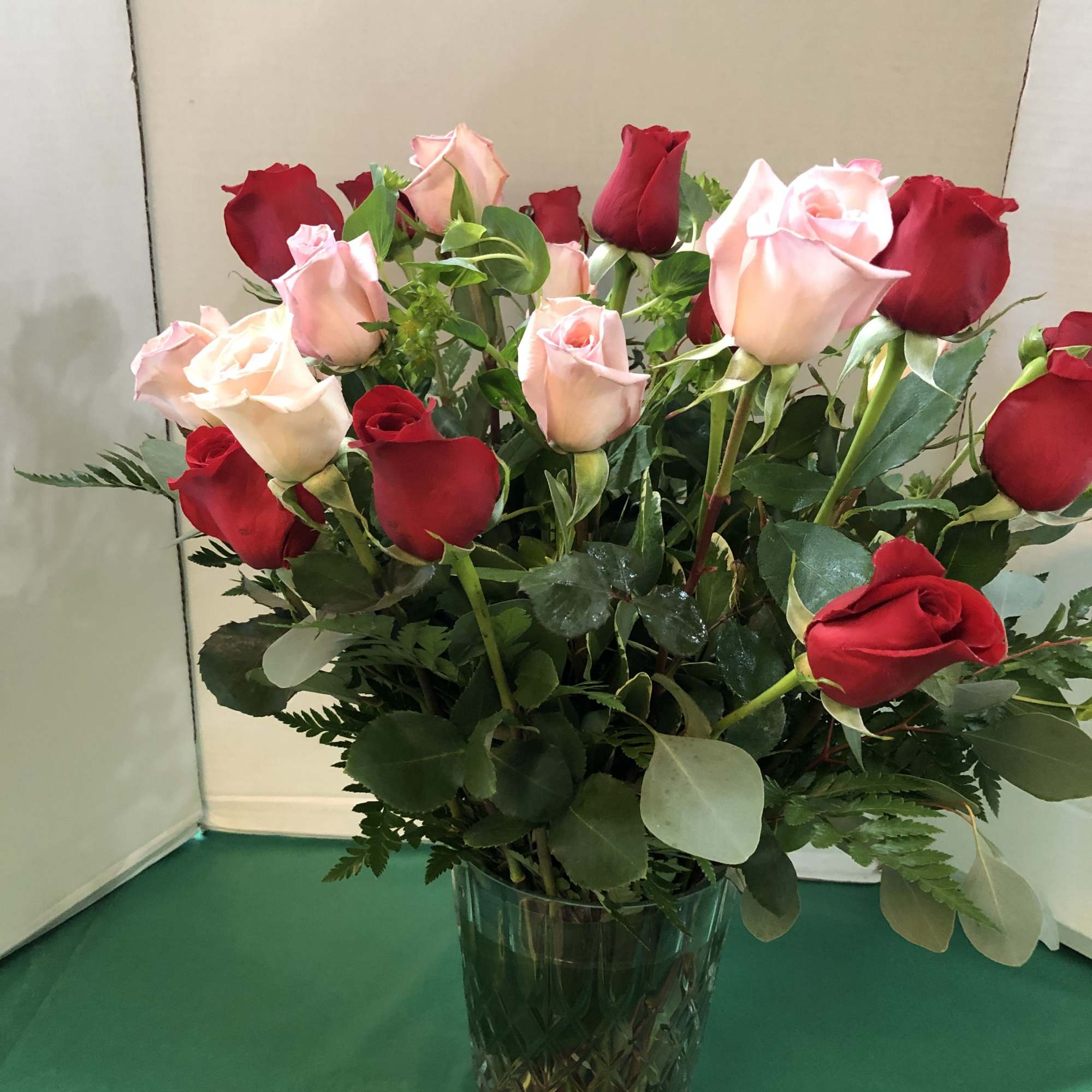 Bouquet of red and blush roses in a glass vase