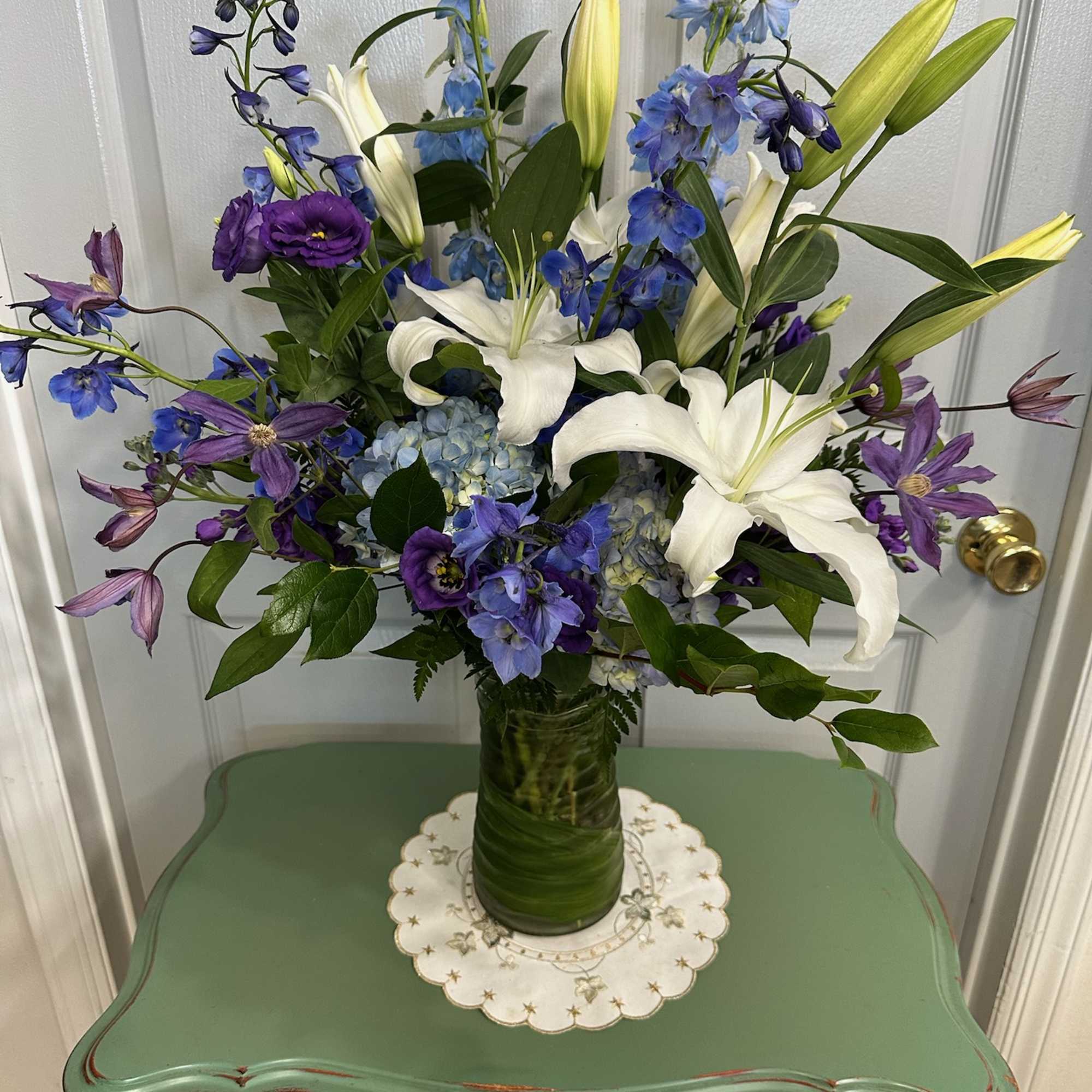 Blue and white floral arrangement in a glass vase