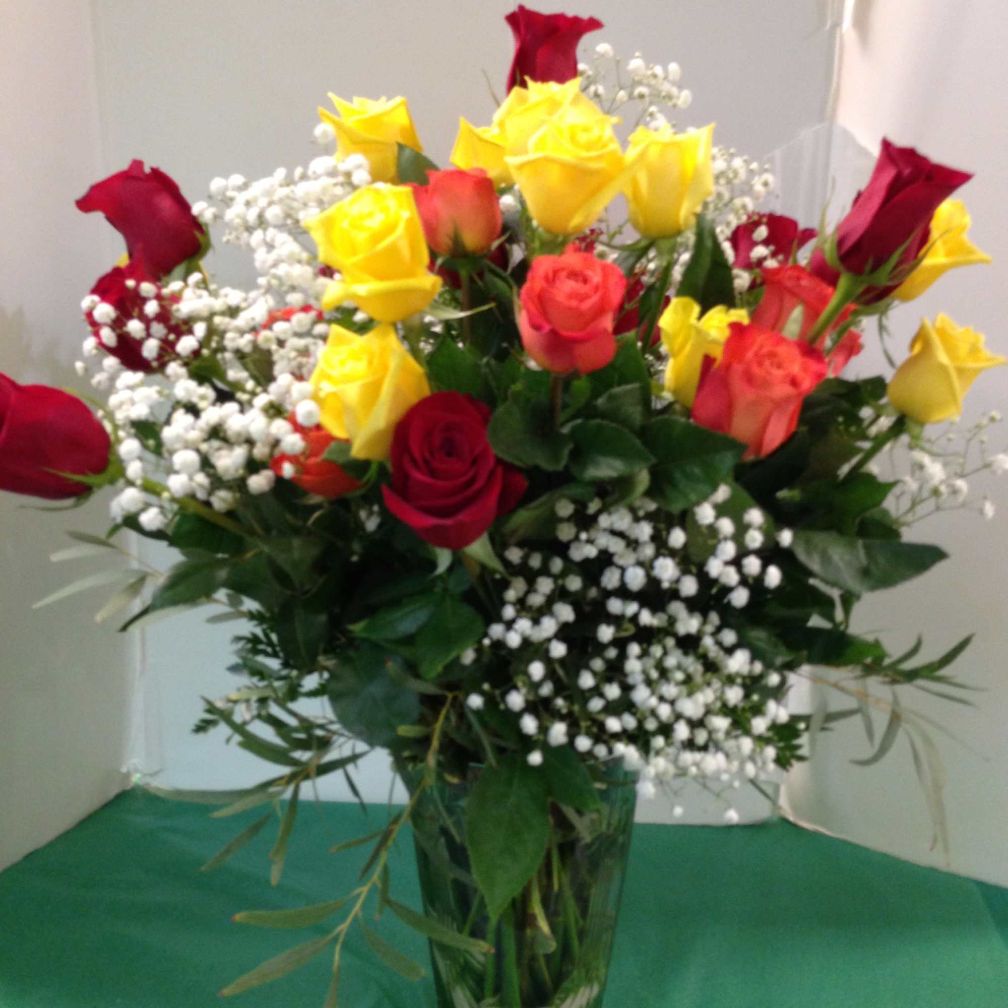 Bouquet of red and yellow roses in a glass vase