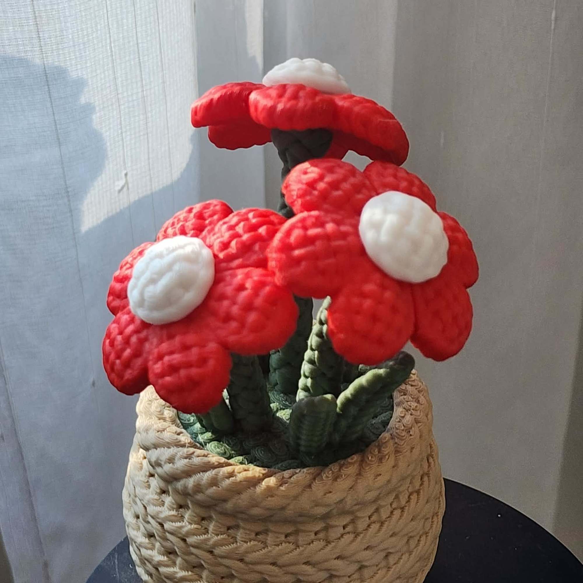 Red and white mushroom-shaped floral sculpture in a woven basket