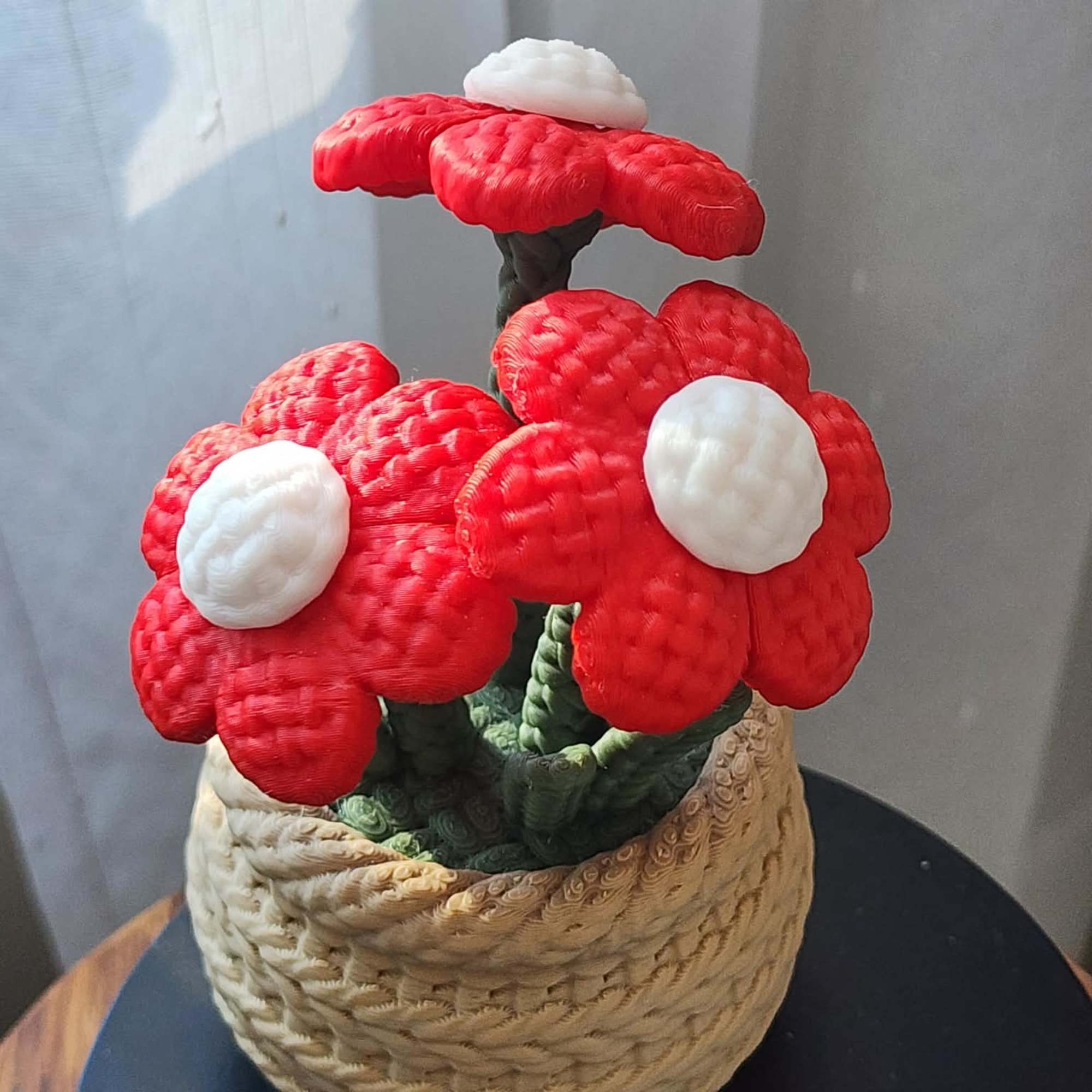 Basket of red and white artificial flowers with a woven container