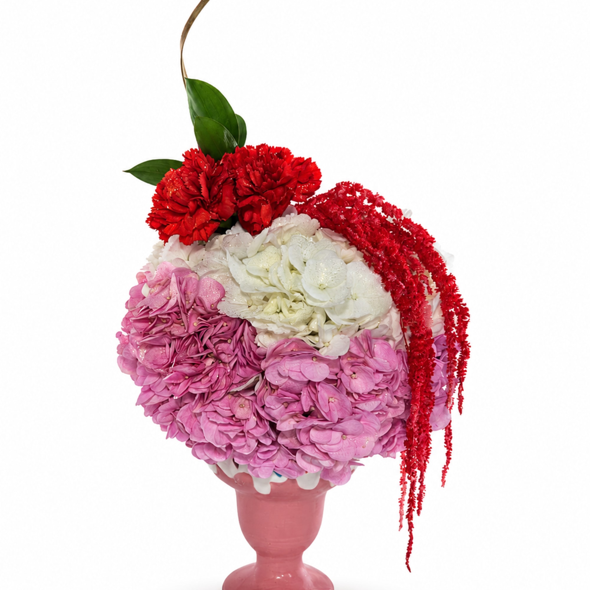 Pink and white floral arrangement in a pink vase with red accents