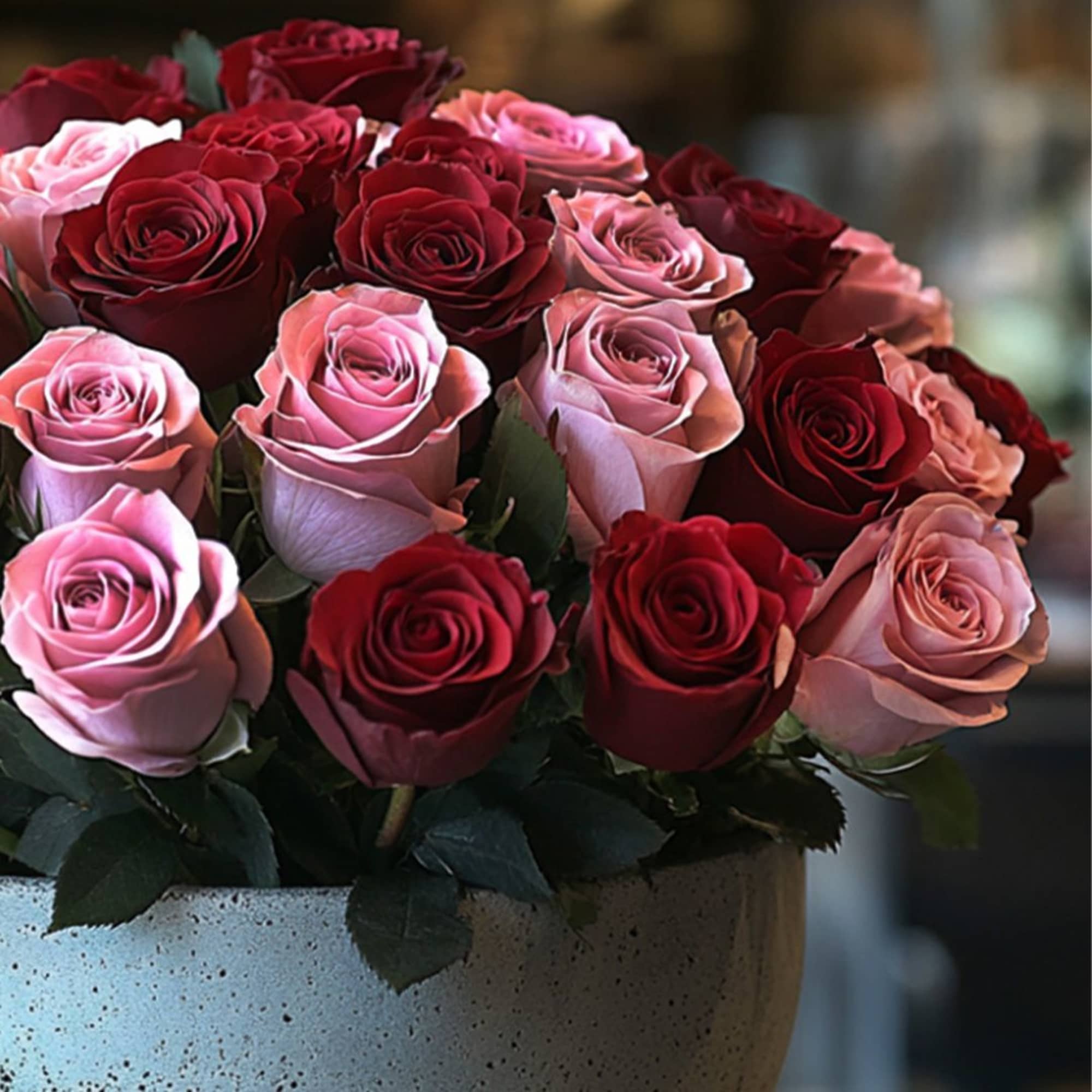 Bouquet of red and pink roses in a ceramic vase