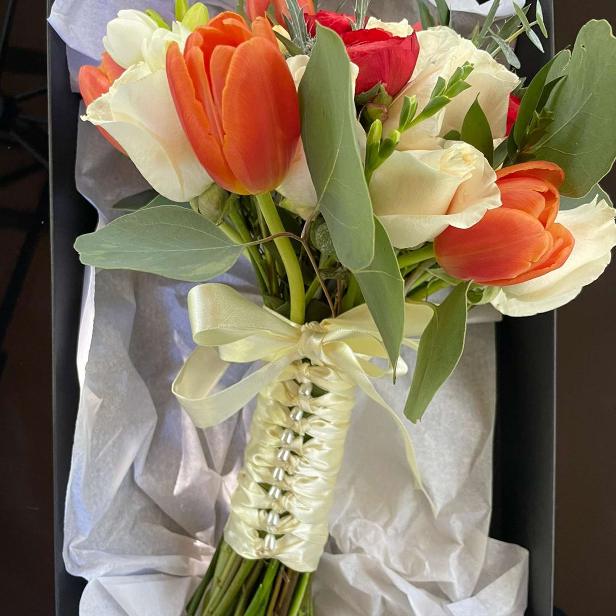 A classic bridal bouquet of roses and tulips hand-tied with ribbon with, photo 2 of 2