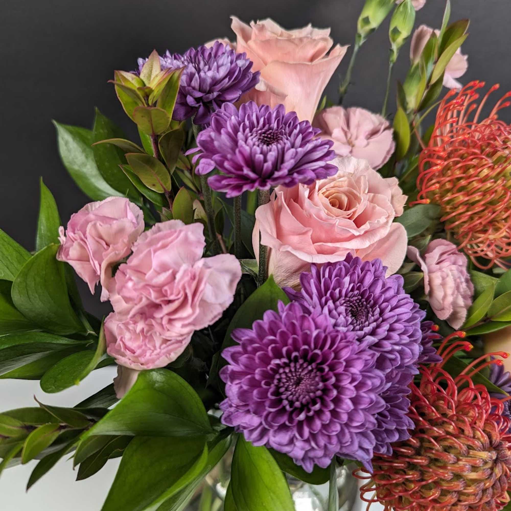 Pink and purple mixed bouquet in a glass vase, photo 2 of 3
