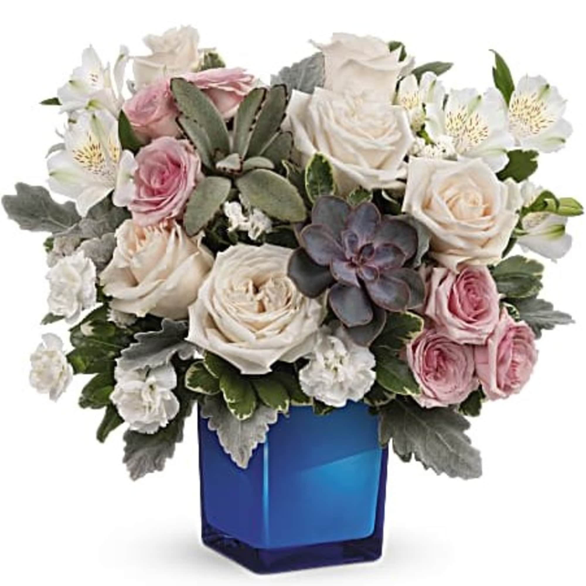 Pink and white roses with succulents in a blue glass vase