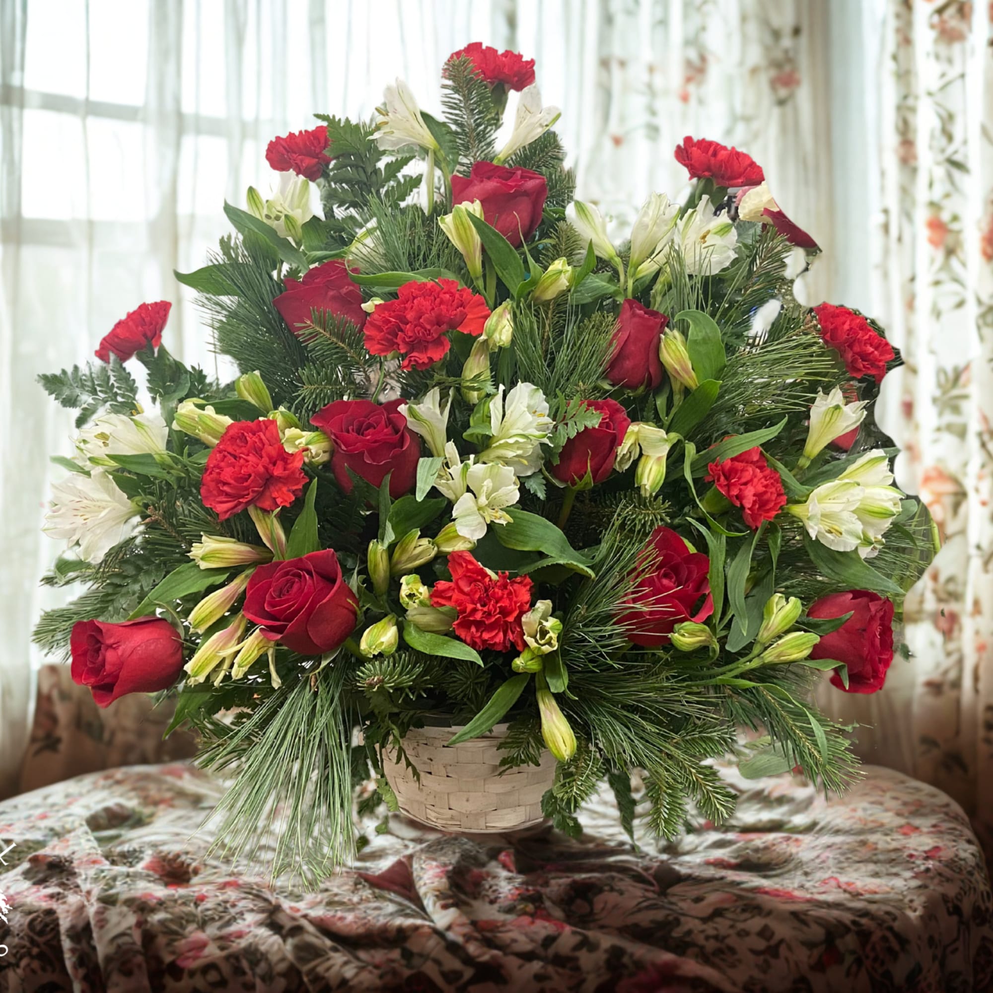 Red roses and white lilies in a basket arrangement