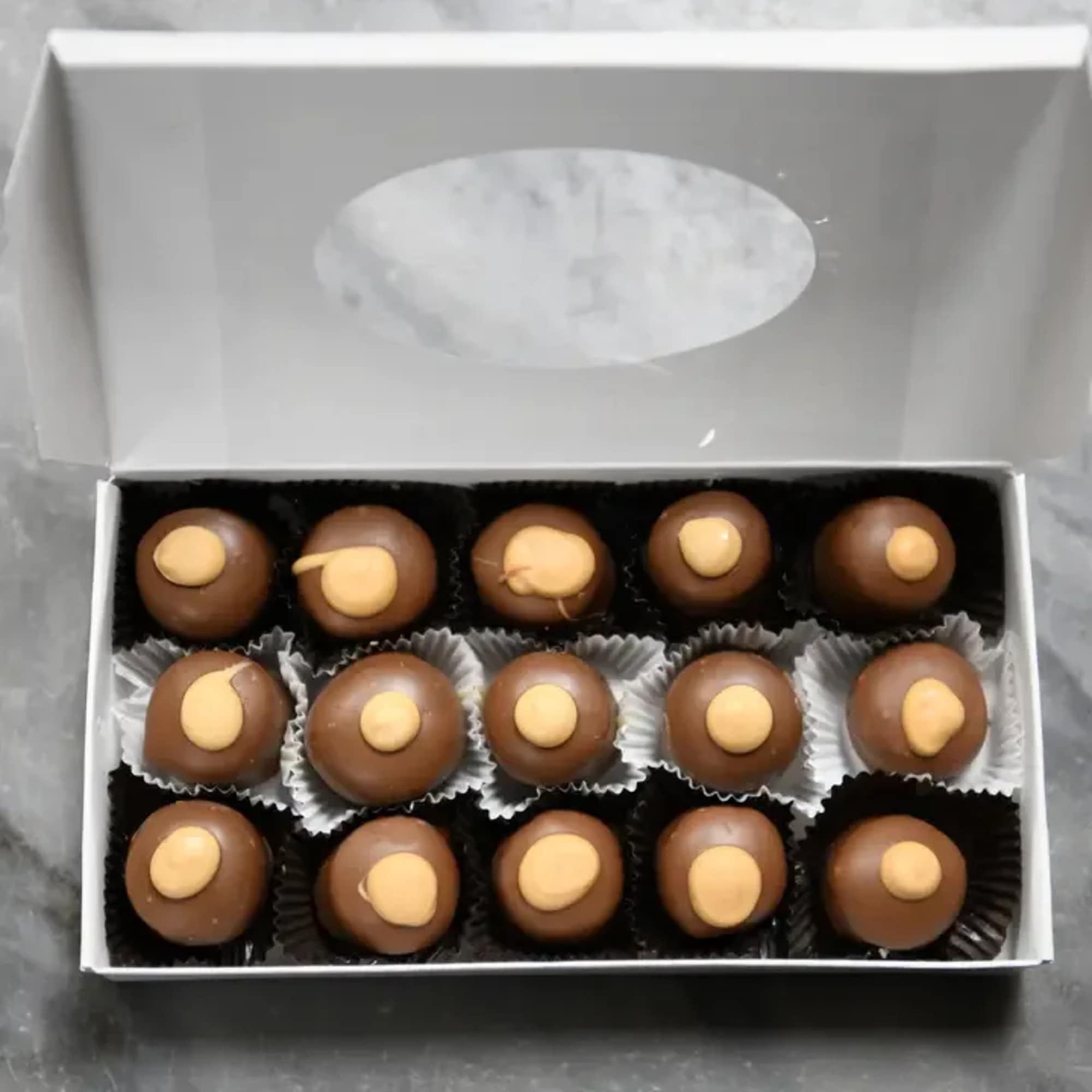 Box of chocolate truffles with yellow centers
