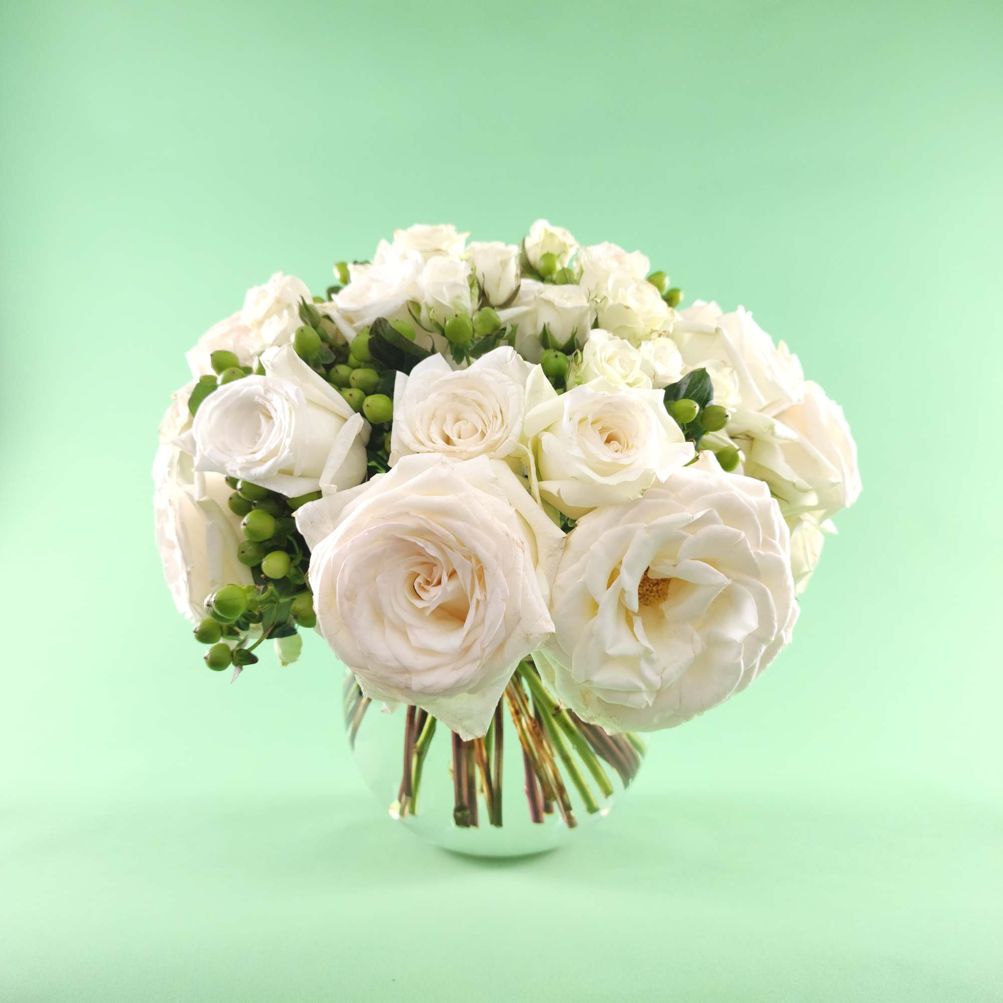 White rose bouquet in a clear glass vase