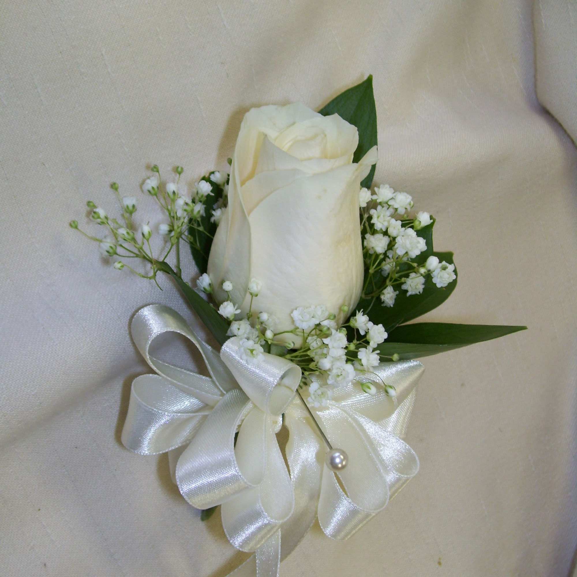 White rose boutonniere with baby's breath and satin ribbon